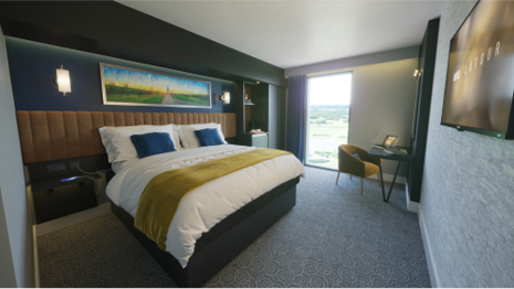 Modern event room with plush bed at Hotel La Tour for meetings and relaxation.