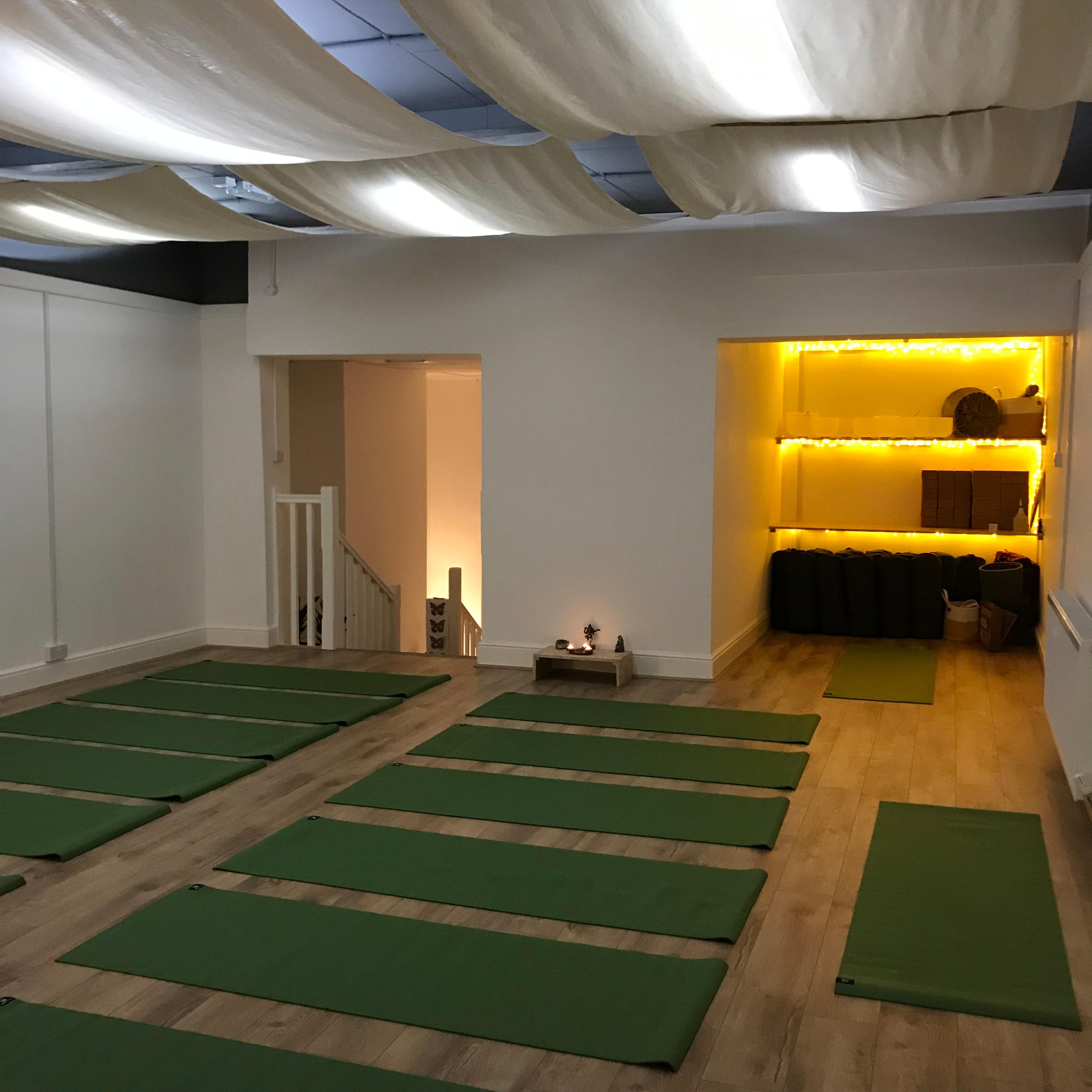 Serene yoga studio with warm lighting, ideal for wellness retreats and mindfulness workshops.