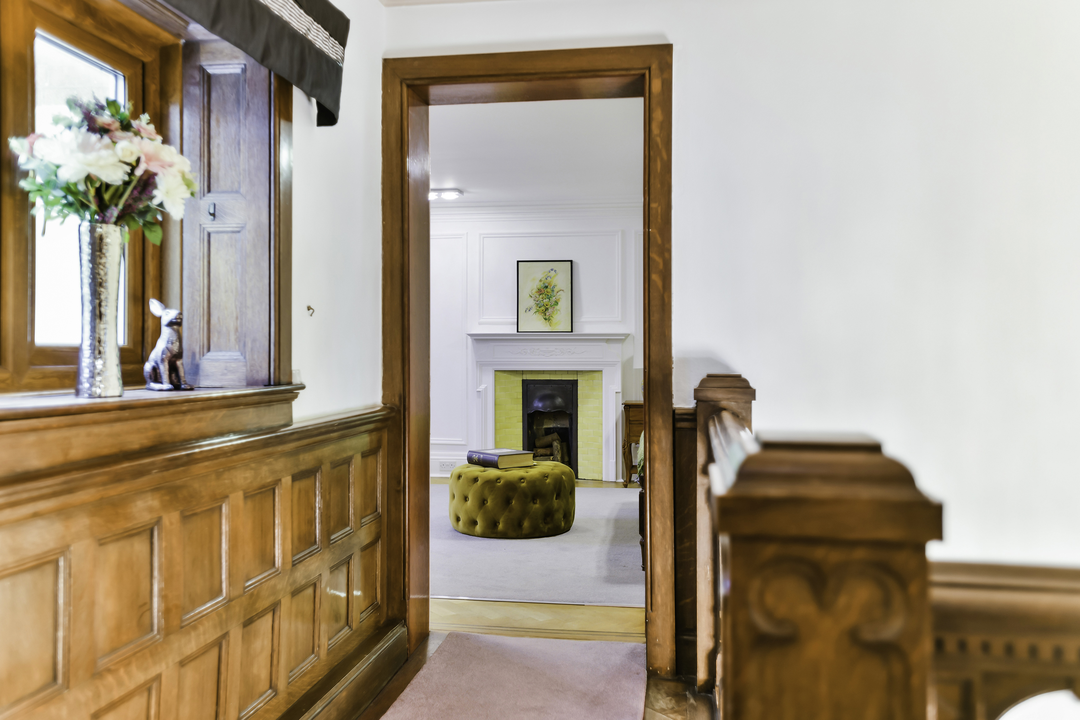 Kingswood Manor corridor with warm wood paneling, perfect for cozy meetings and gatherings.