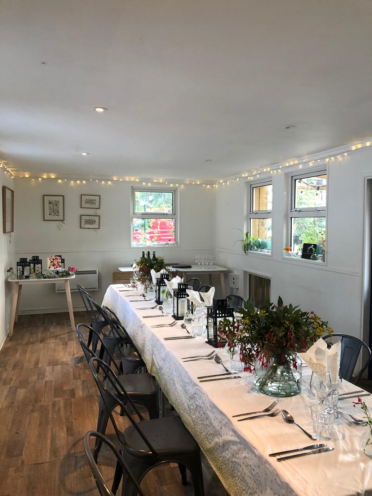 Elegant event space with long table, ideal for intimate gatherings and meetings.