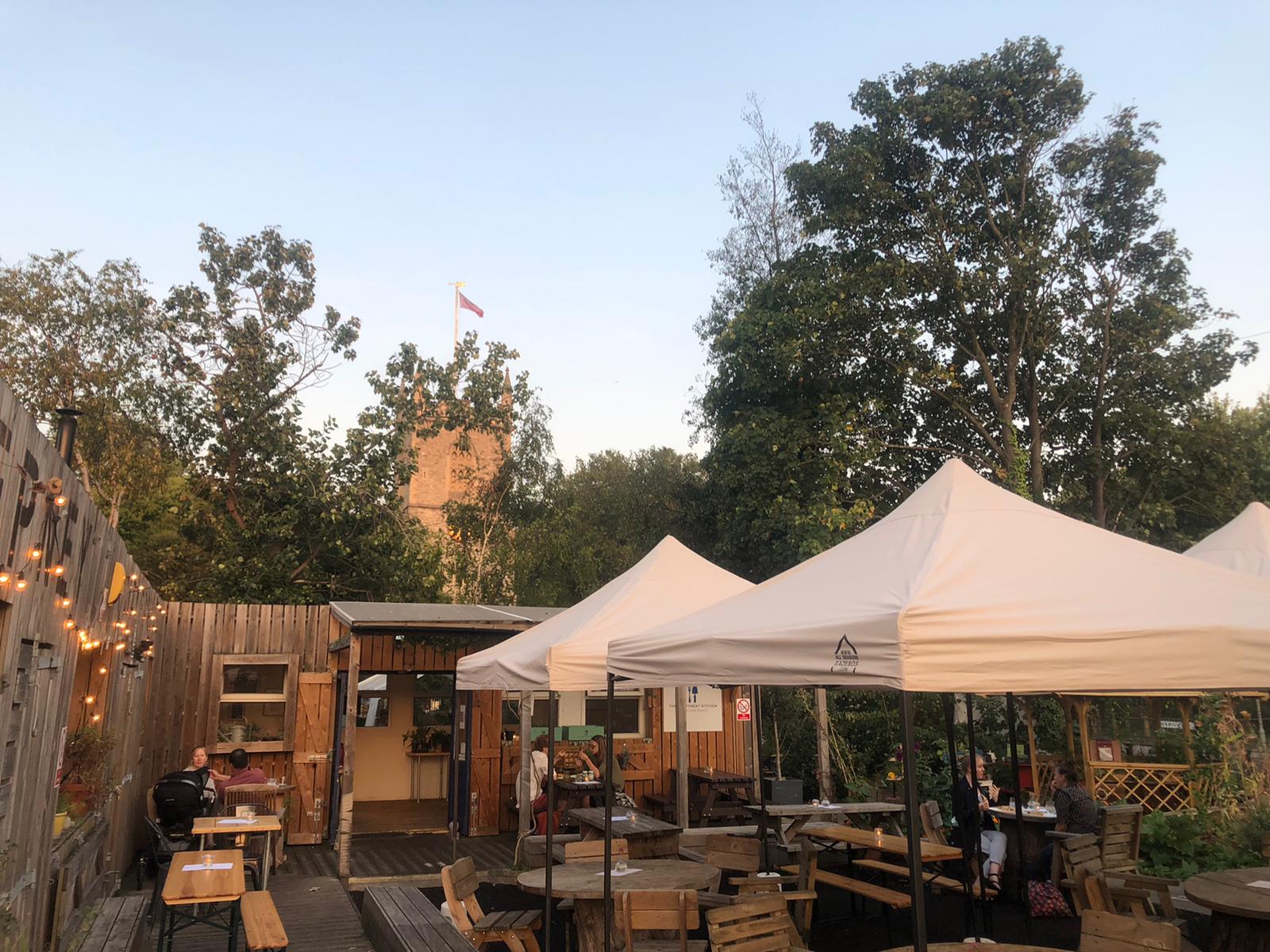 Outdoor event space with white canopies, ideal for summer gatherings and team-building.