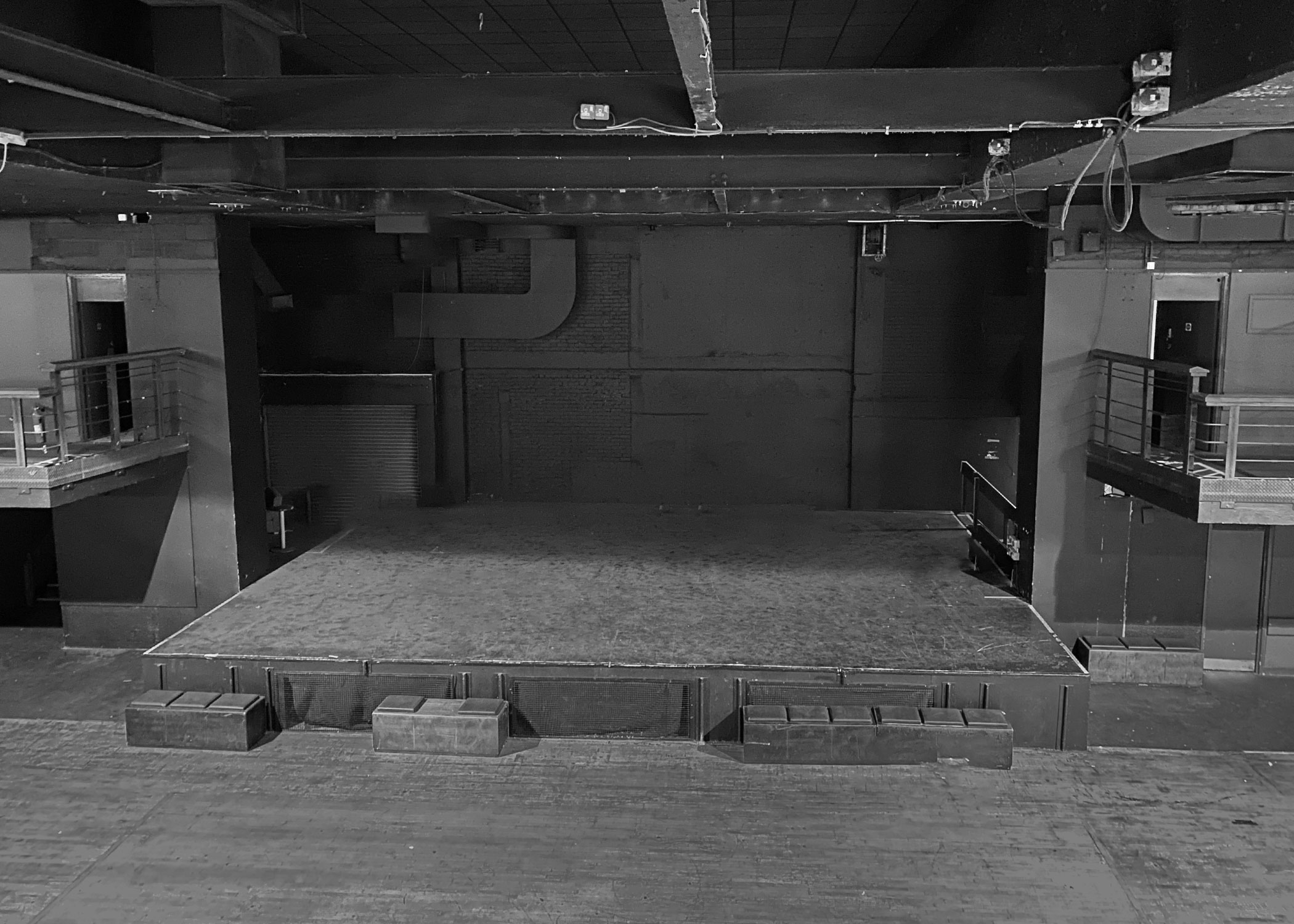 Versatile event space at Forum HQ, featuring a spacious stage for presentations and performances.