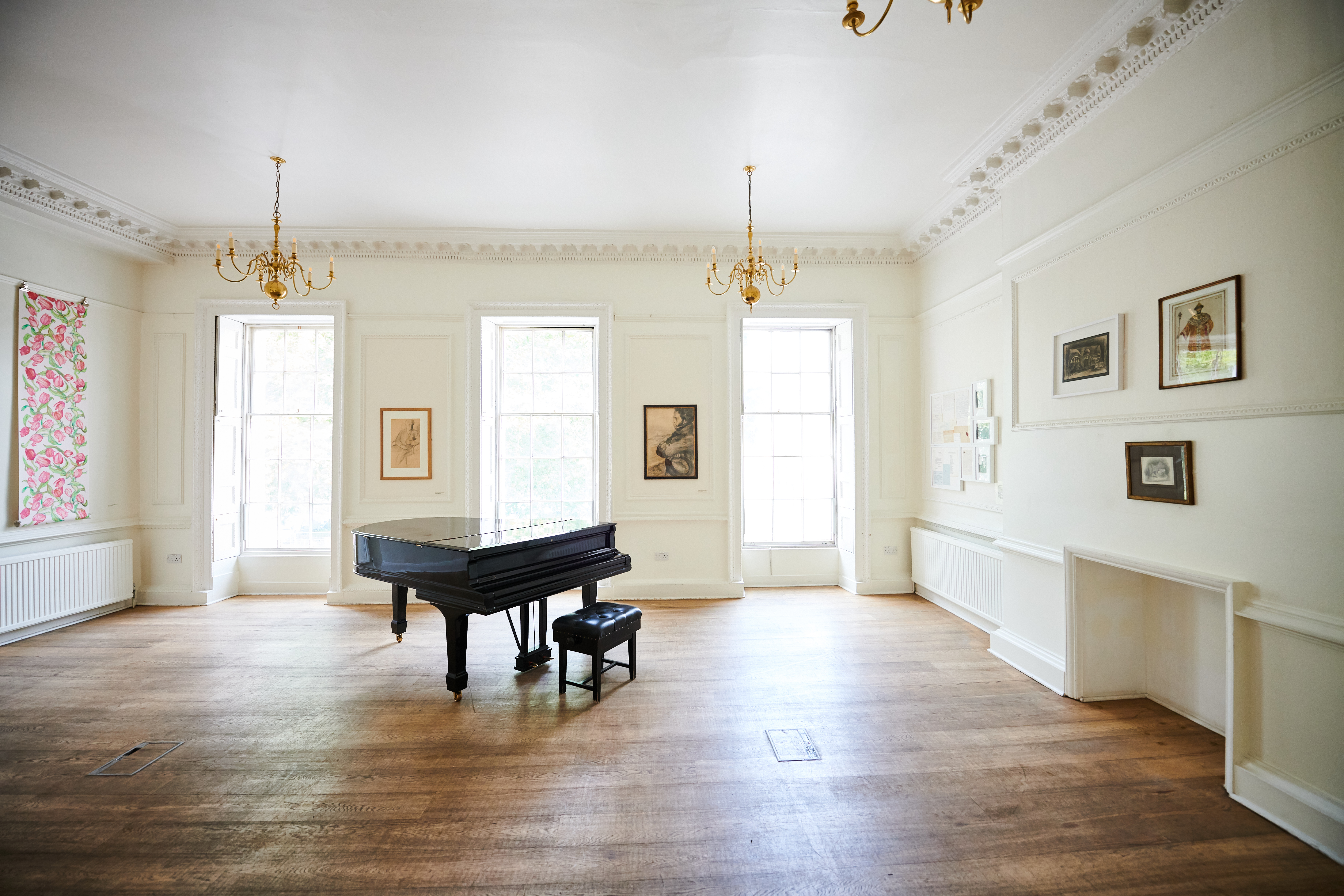 Elegant music room with grand piano, ideal for workshops and private events.