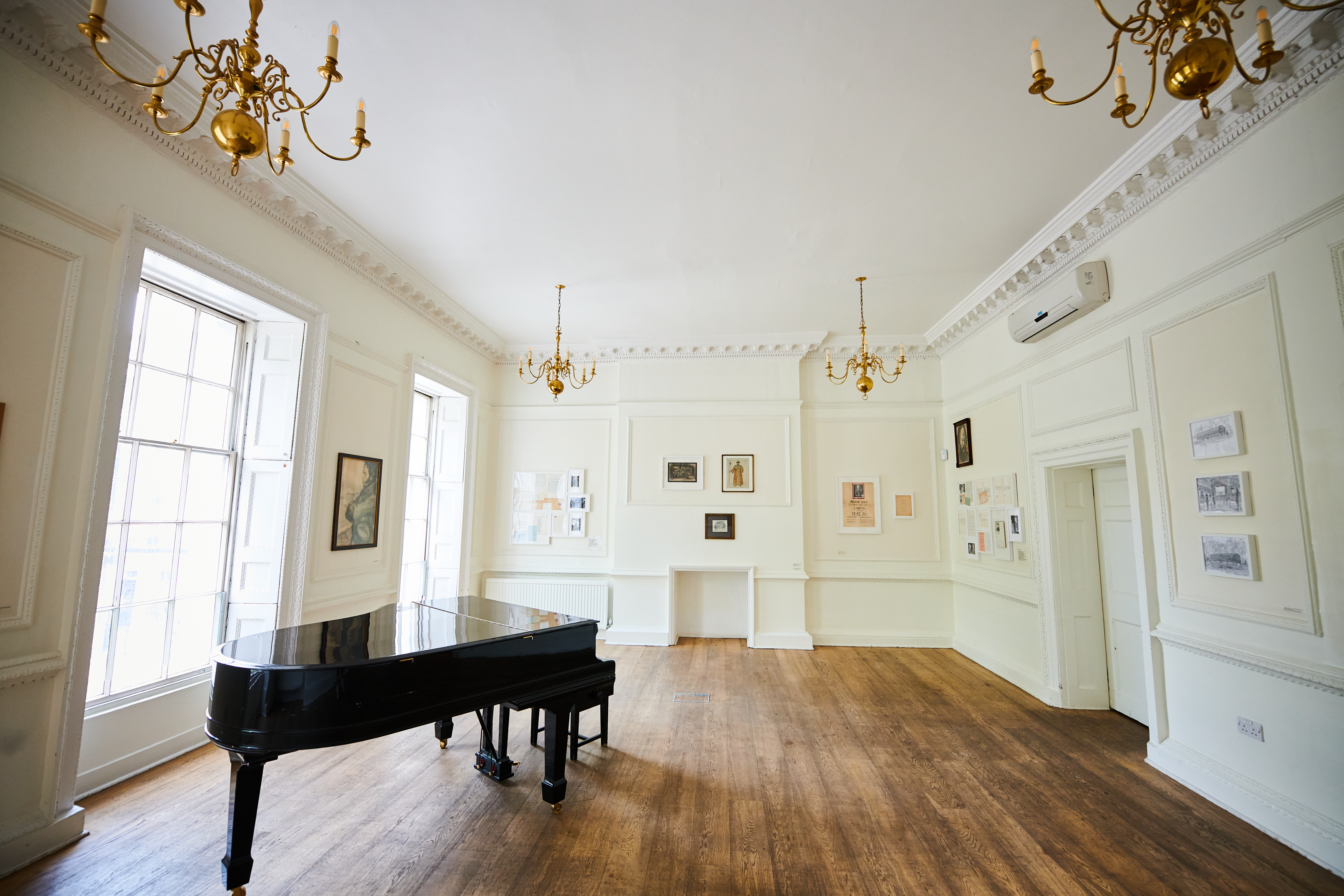 Elegant music room with grand piano, perfect for corporate events and performances.