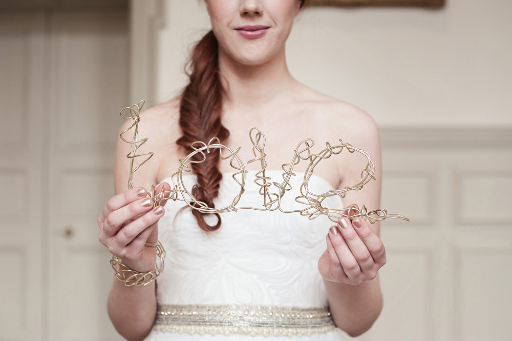 Elegant wedding decor with "love" wire sculpture at Royal Geographical Society event.