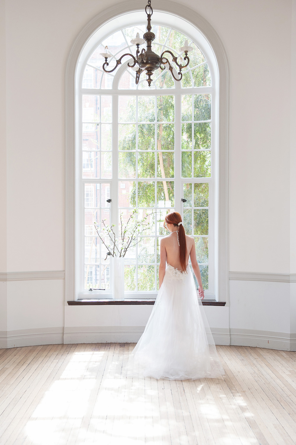 Bride in backless wedding dress at Royal Geographical Society, ideal for elegant weddings.