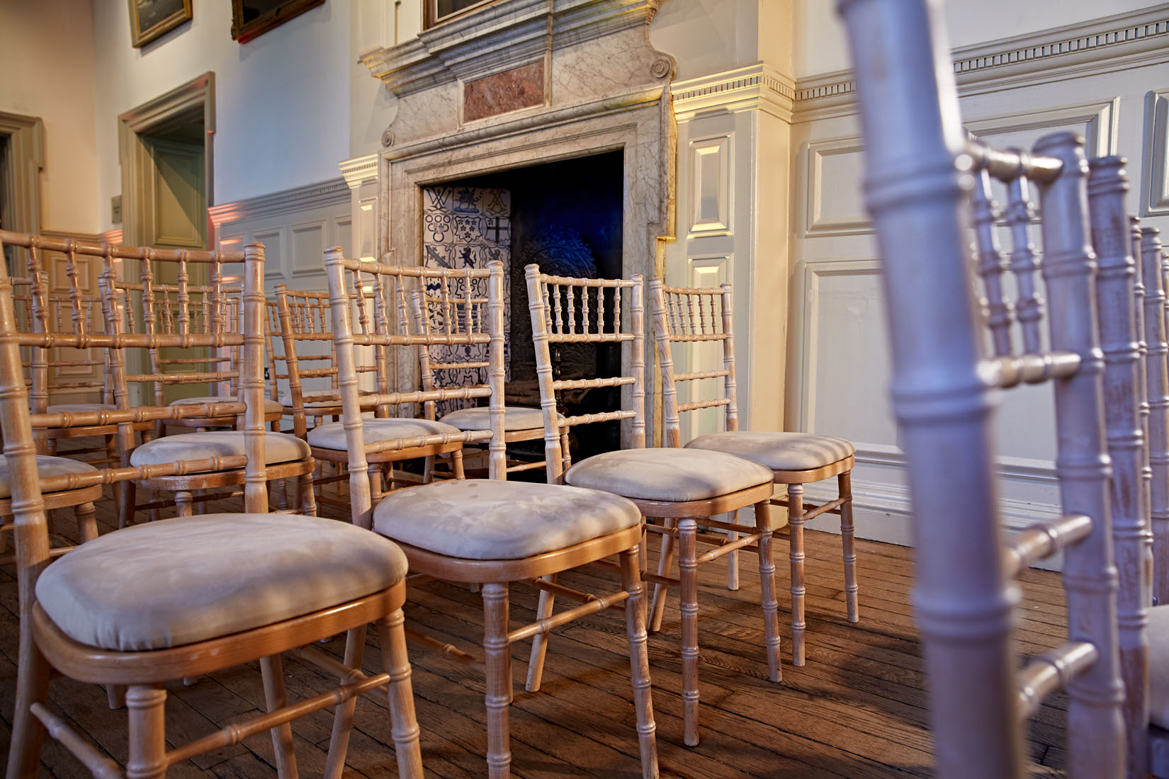 Elegant chiavari chairs in a wedding setup at the Royal Geographical Society.