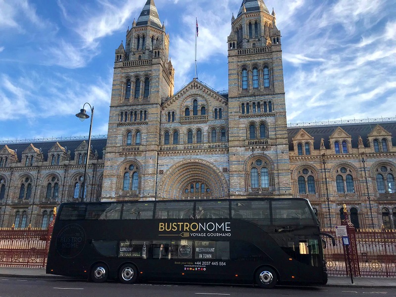 Bustronome bus venue for unique corporate events near historic building.