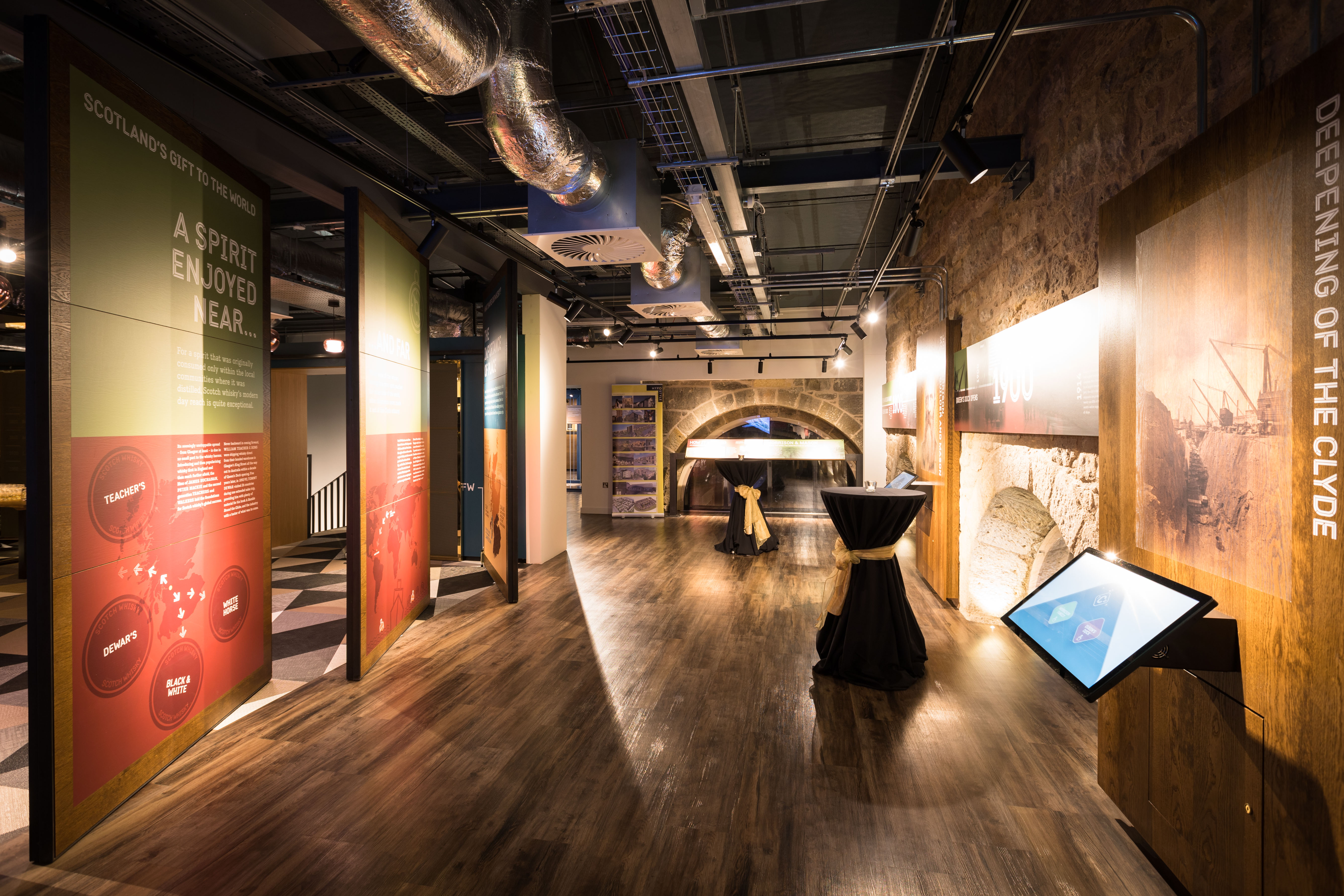 Modern event space at The Clydeside Distillery with interactive displays for gatherings.