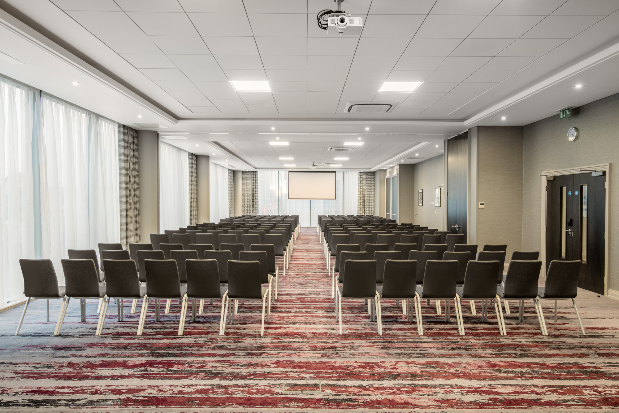 Docklands Suite meeting room with projector screen, ideal for conferences and seminars.