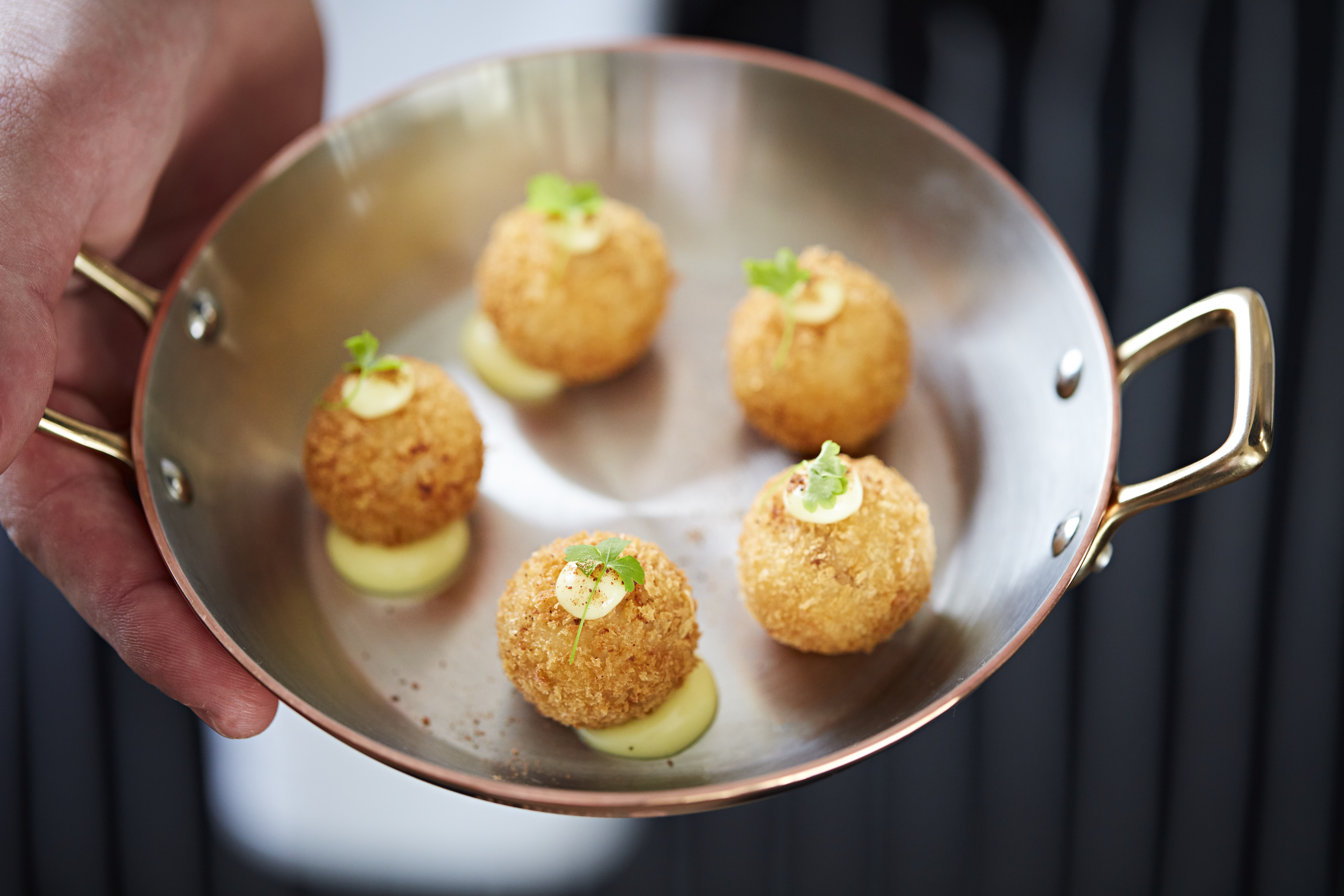 Crispy golden hors d'oeuvres in copper pan at Holmes Hotel London event catering.