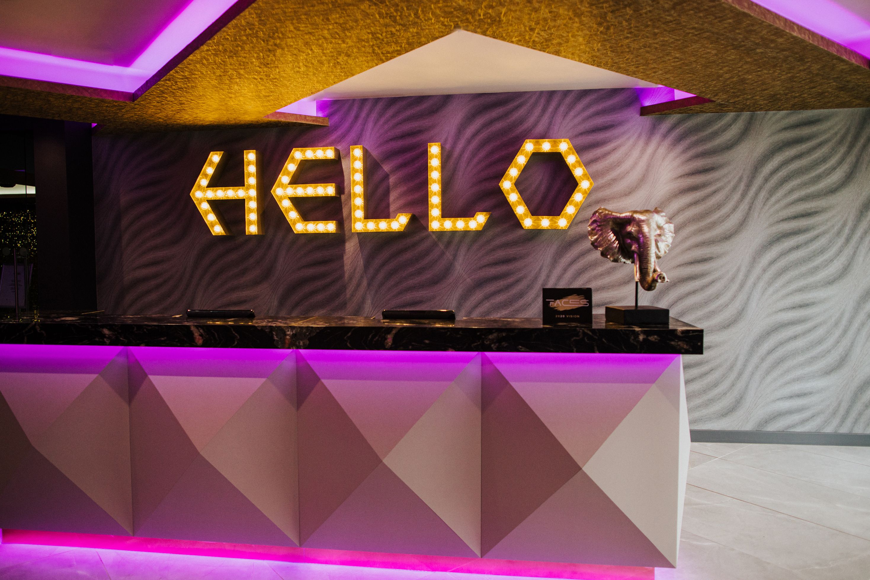 Vibrant reception area with "HELLO" sign, perfect for networking events and gatherings.