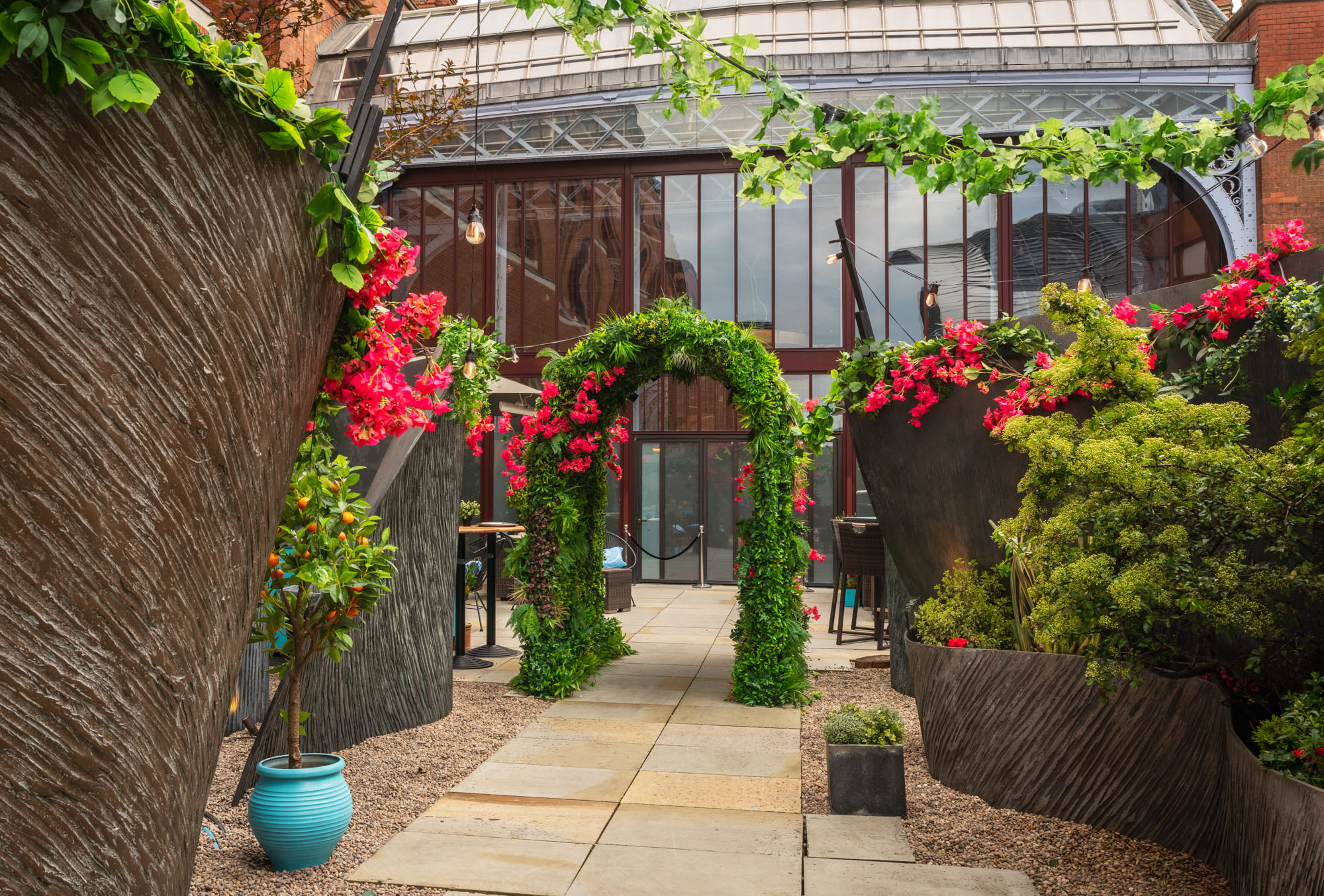 Lush floral archway at RoofGarden St. Pancras, perfect for weddings and garden parties.