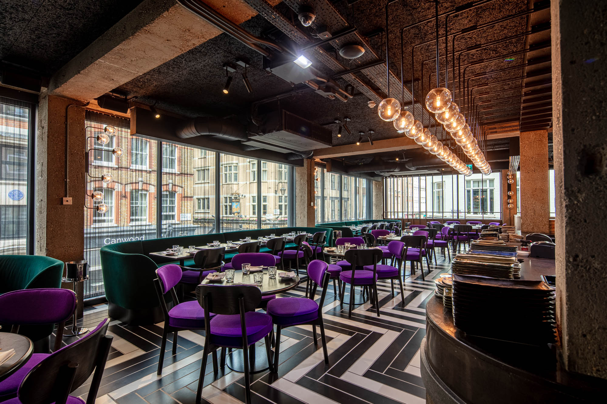 Modern dining room at Chotto Matte with purple chairs, ideal for upscale events.