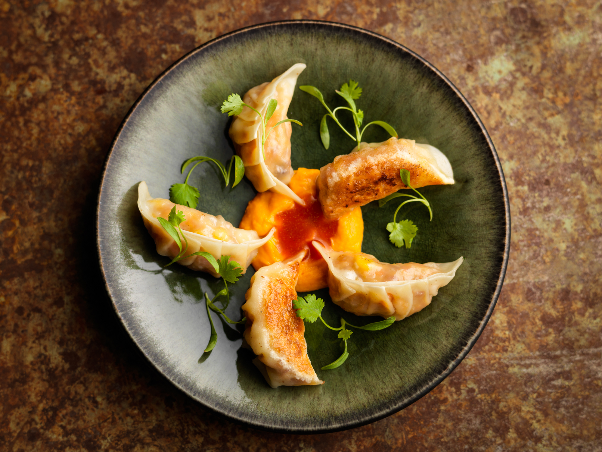 Artfully plated dumplings in Chotto Matte's upscale dining room for events and catering.