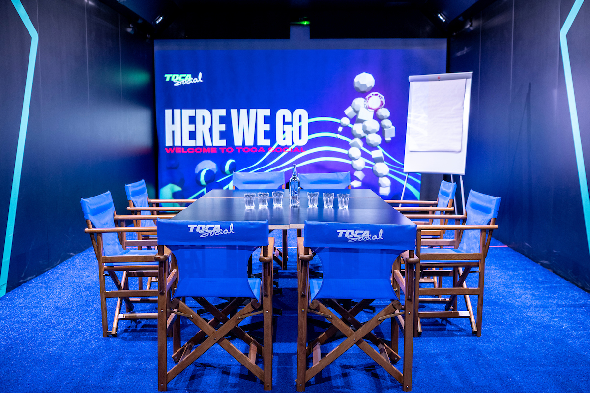 TOCA Social meeting space with vibrant backdrop, ideal for workshops and brainstorming.