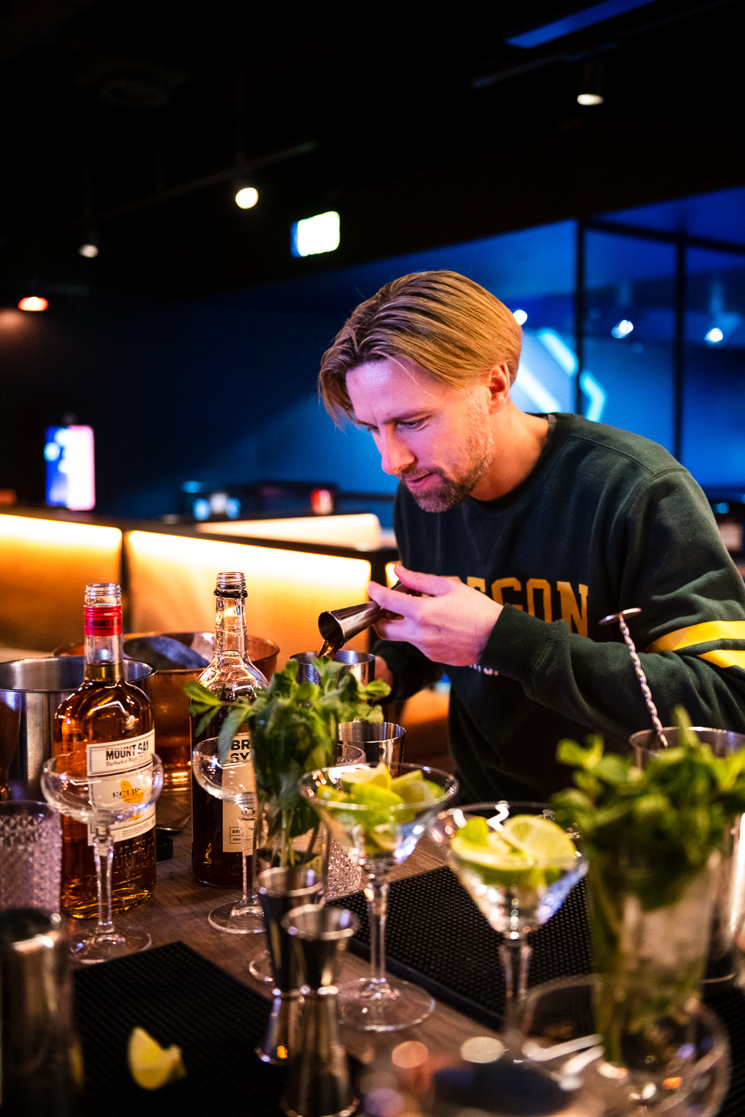 Bartender crafting cocktails at Corner Bar, TOCA Social for engaging networking events.