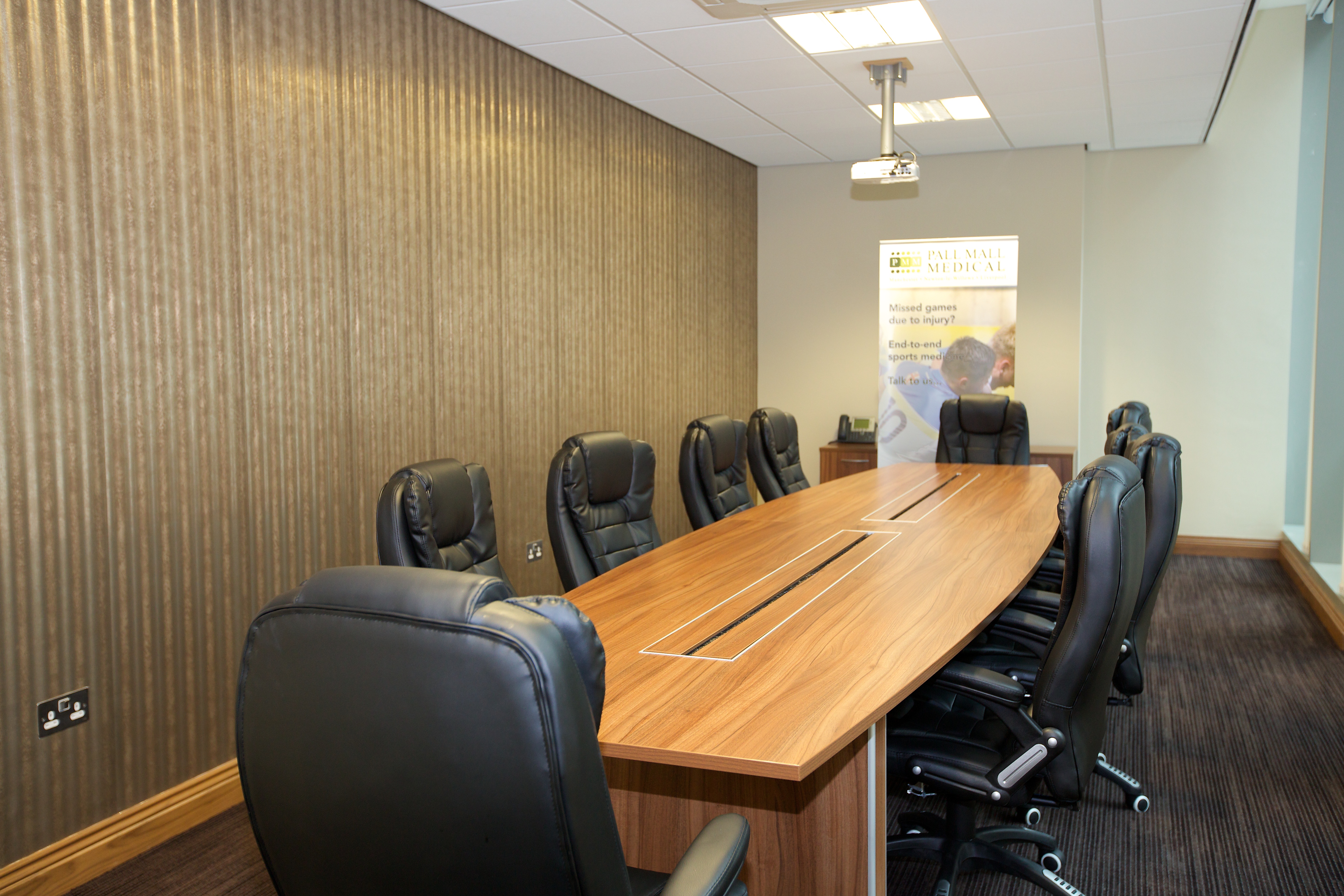 Modern conference room with sleek table, ideal for professional meetings and presentations.