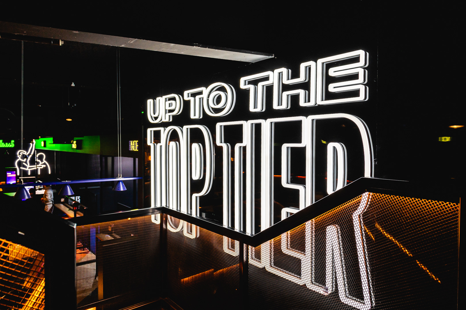 Vibrant Players Lounge at TOCA Social with neon sign, perfect for events and gatherings.