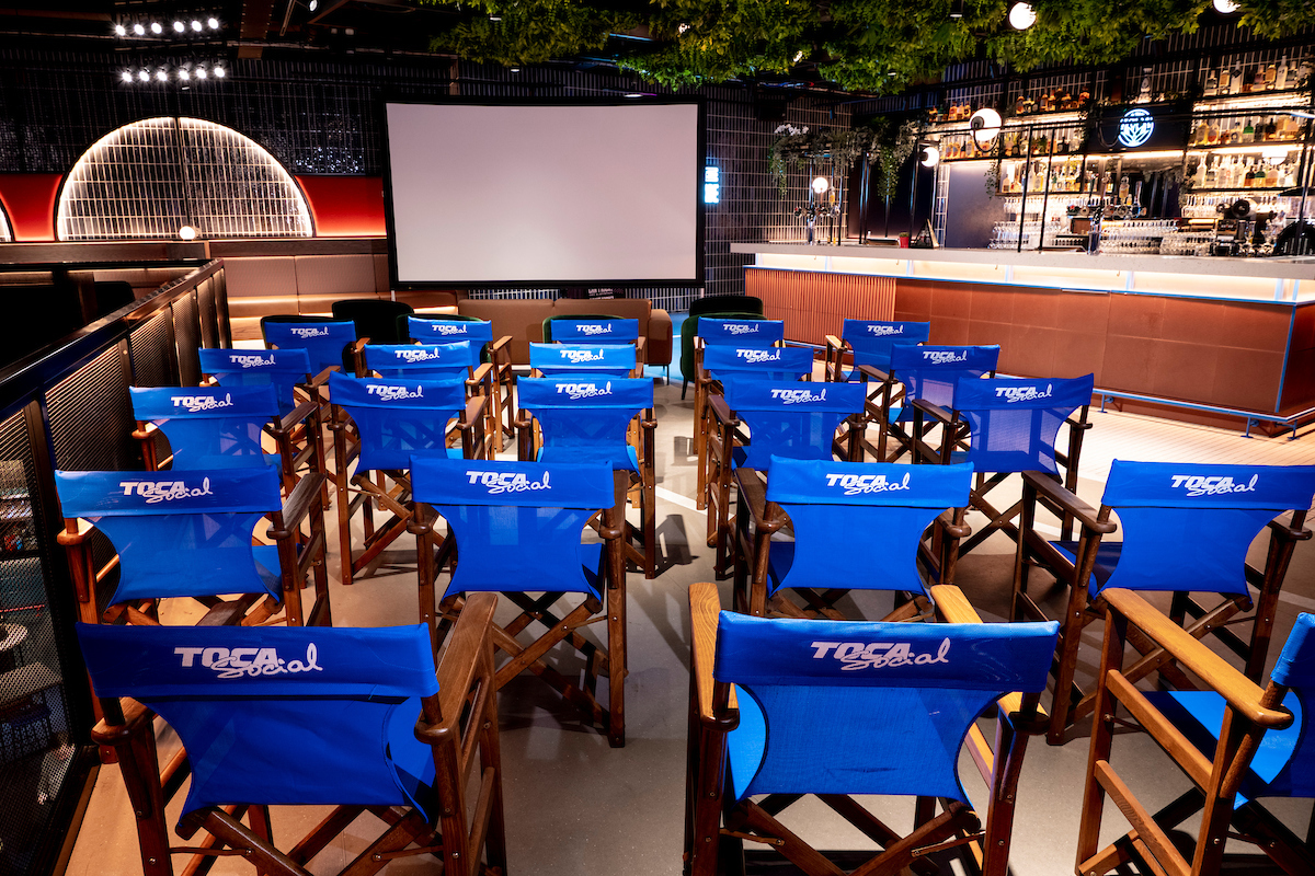 Players Lounge in TOCA Social with blue director's chairs for presentations and networking.