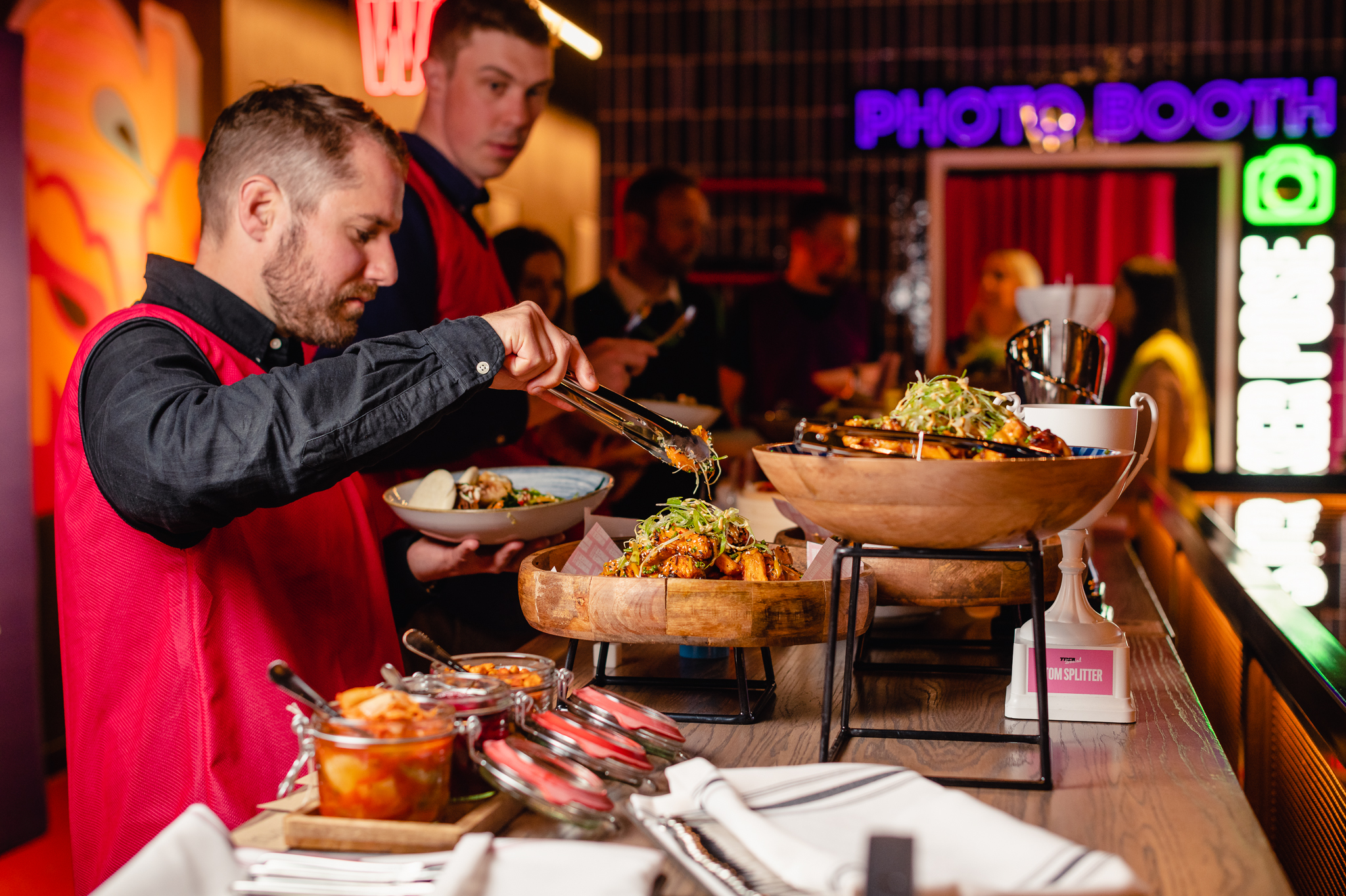 Players Lounge at TOCA Social with vibrant buffet and attentive catering staff for events.