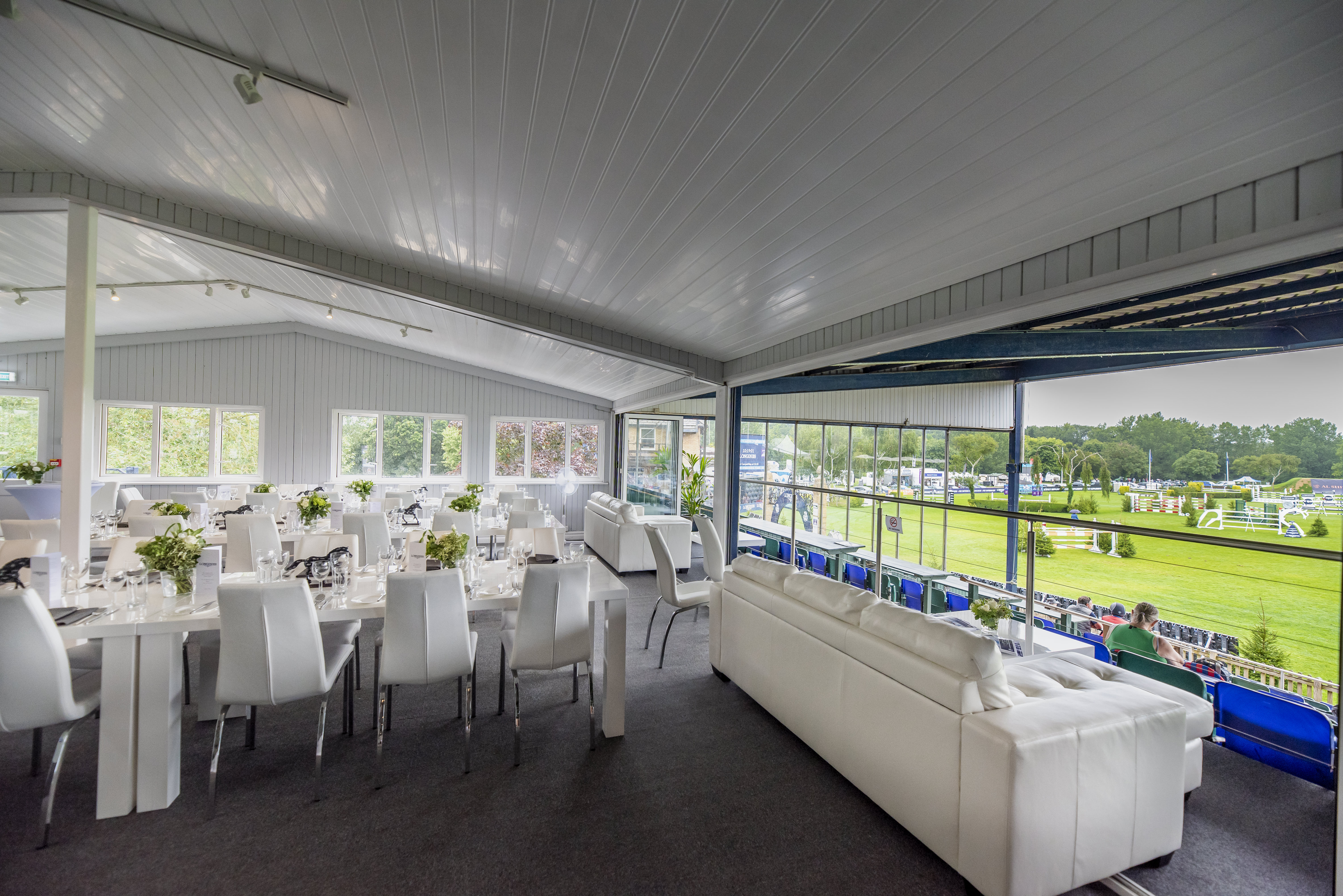 Al Shira'aa Suite at Hickstead: elegant event space with modern decor for upscale gatherings.