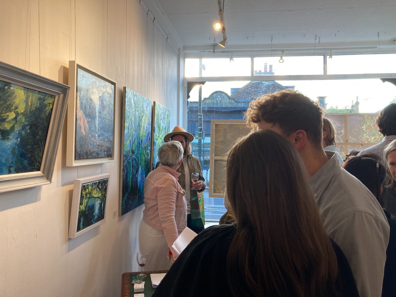 Vibrant art gallery with natural light, perfect for networking events and gatherings.