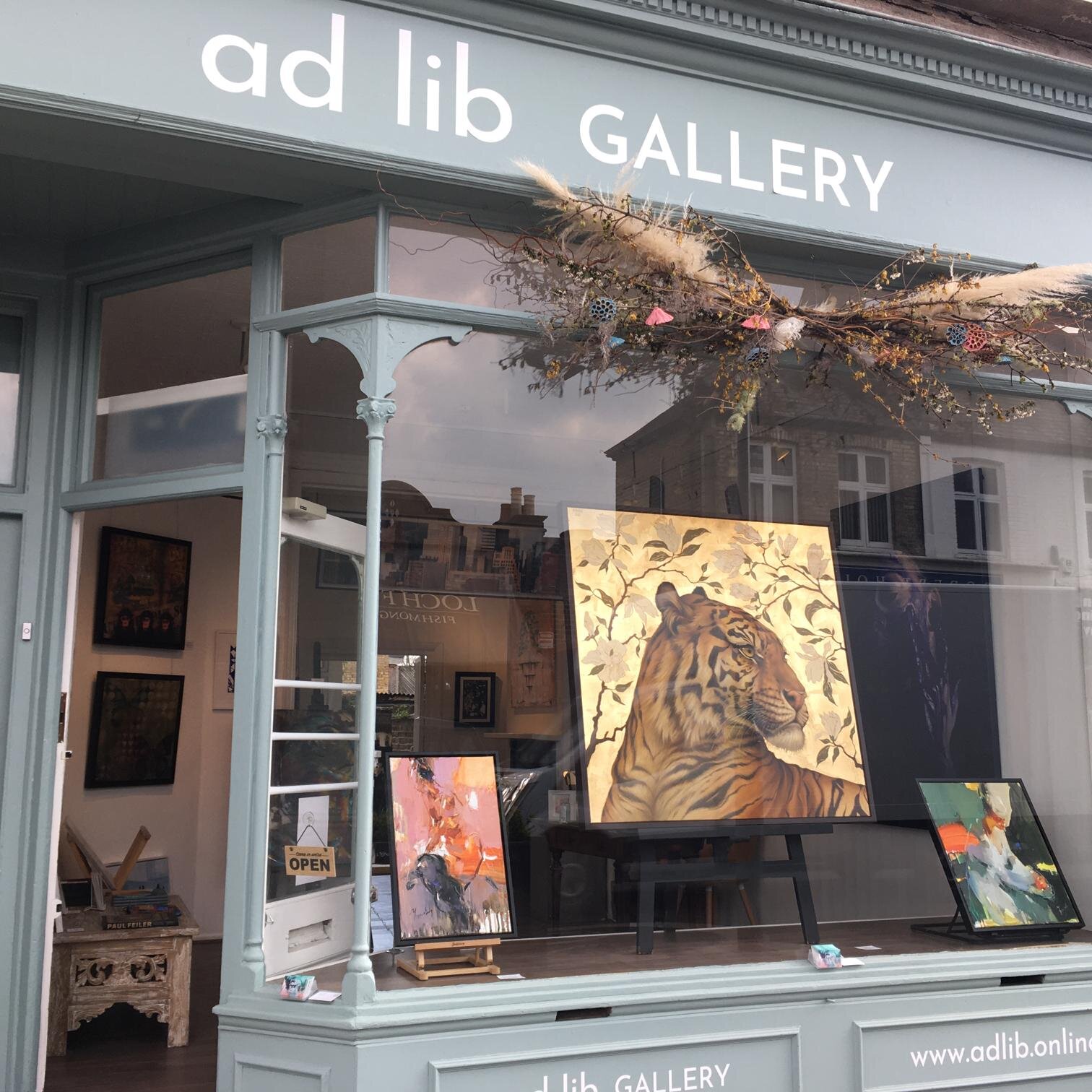 Charming Ad Lib Gallery with striking tiger painting, ideal for art exhibitions and events.