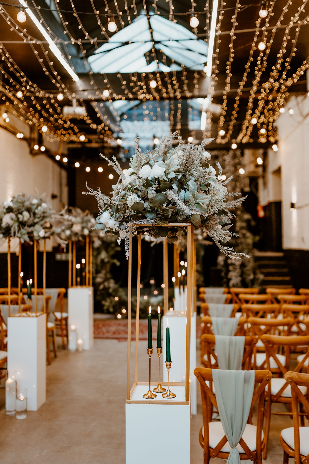 Elegant wedding event space with floral centerpieces and warm ambient lighting.