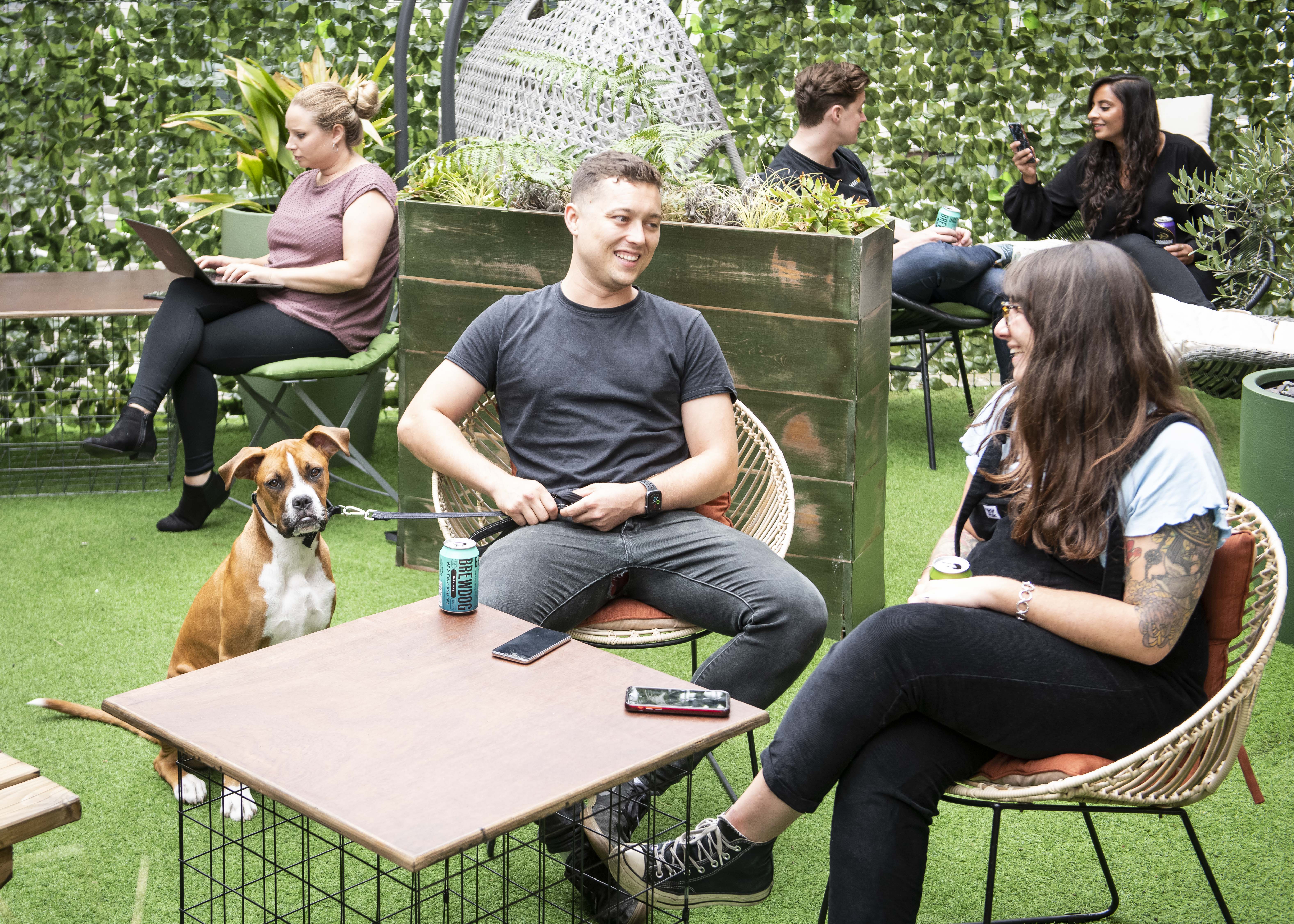 Outdoor meeting space at Runway East Soho with greenery, ideal for team-building events.