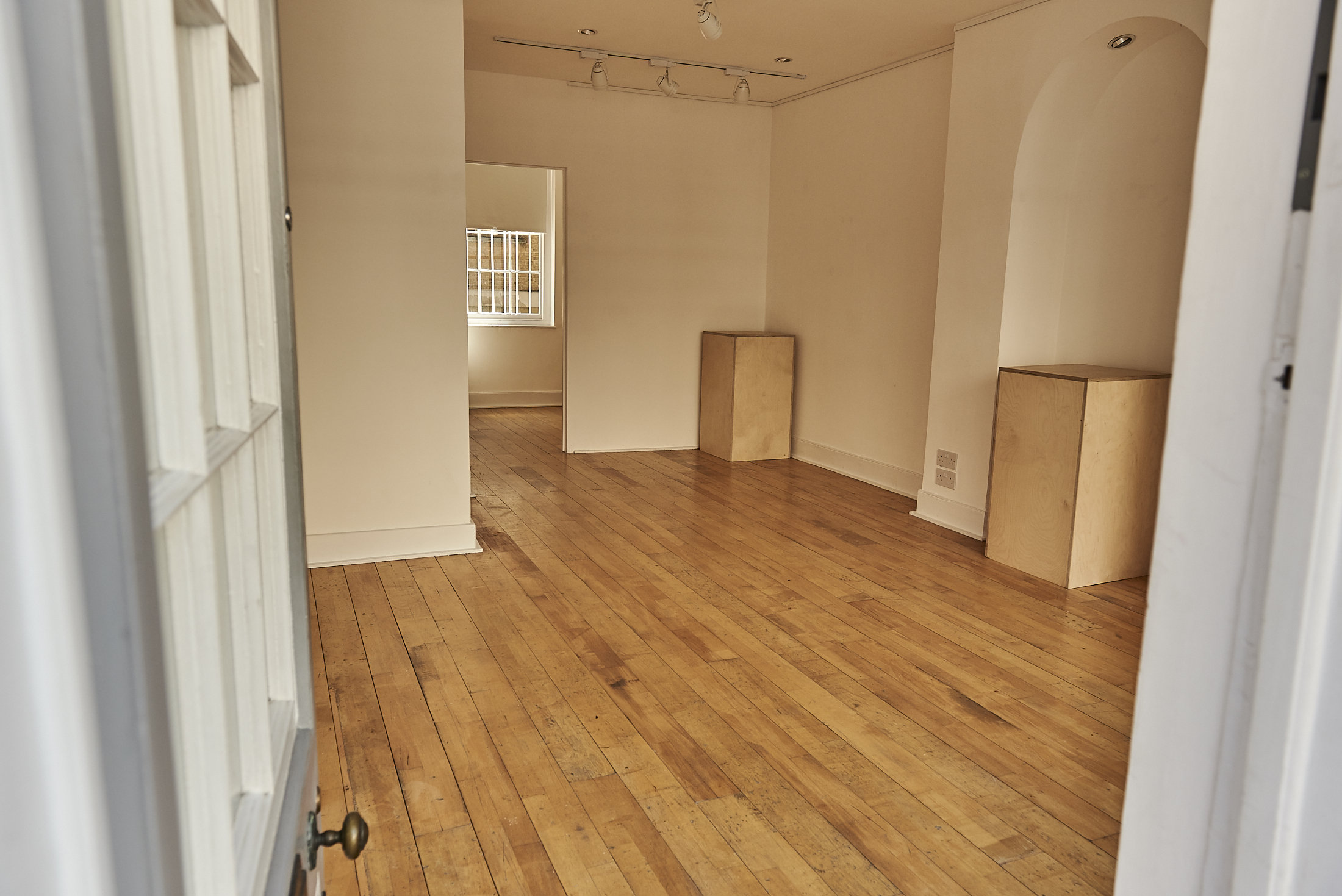 Versatile event space with polished wooden floors at 67 York Street Gallery for workshops and meetings.