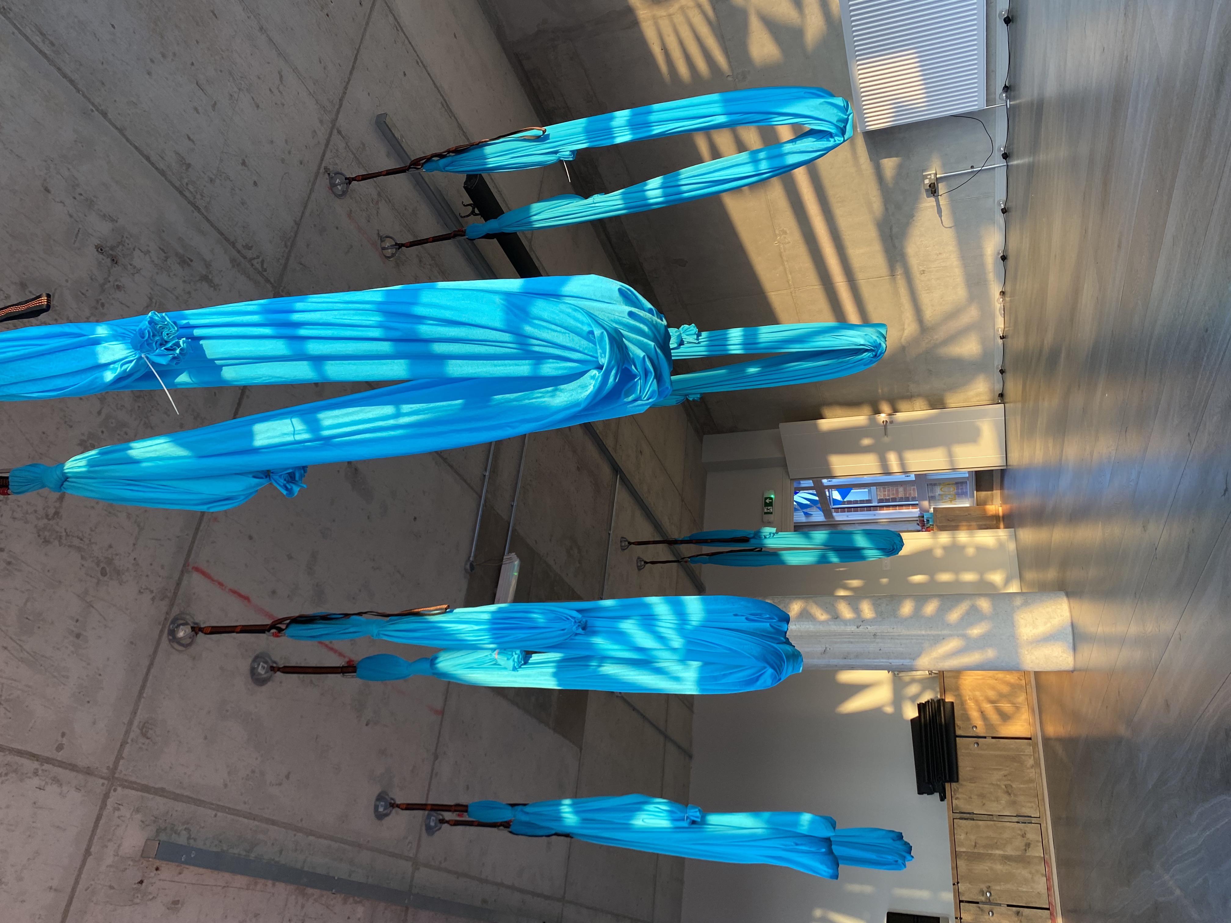 Surya Studio 2 with blue fabric installations, ideal for yoga and creative workshops.