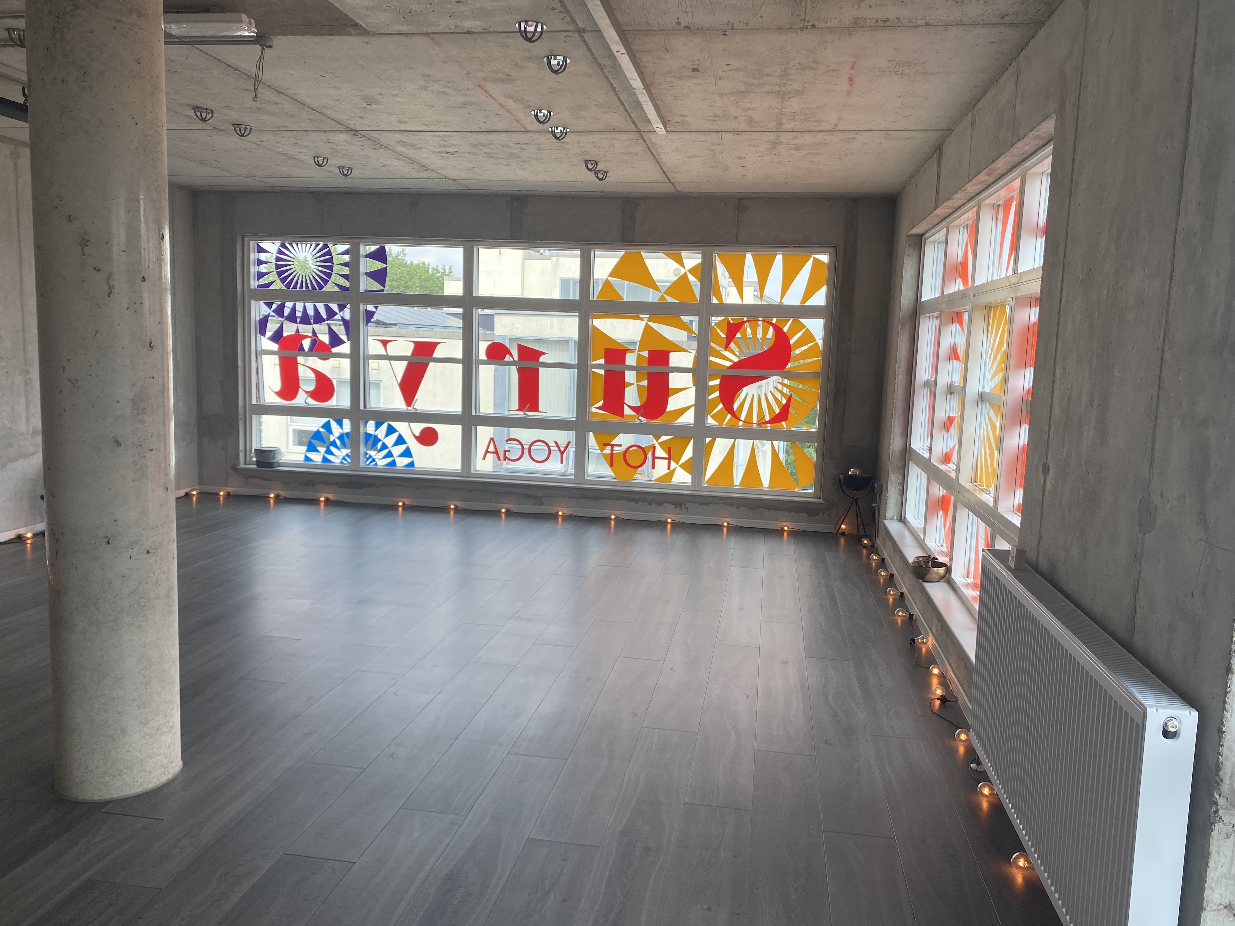 Bright Surya Studio 2 with large windows, ideal for yoga sessions and workshops.