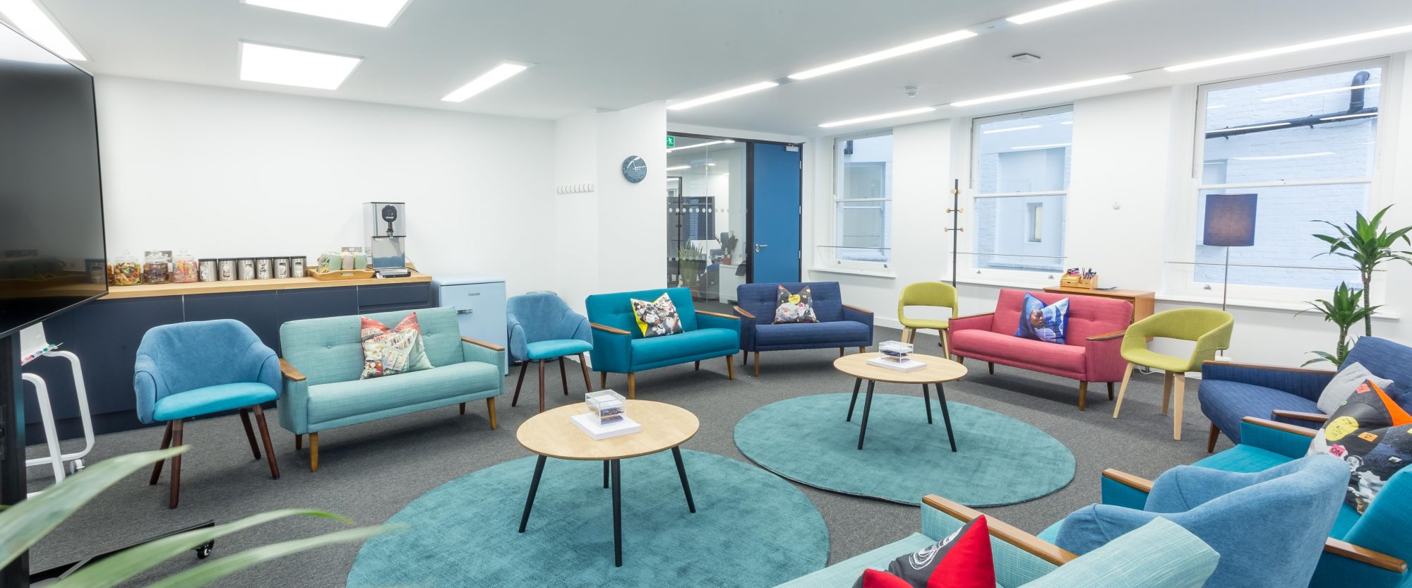 Modern lounge area with vibrant furniture for networking and informal meetings at Wallacespace.