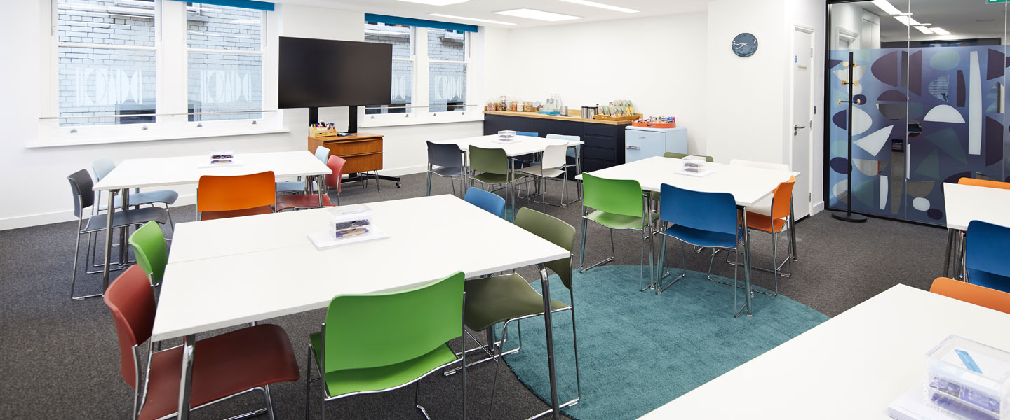 Modern meeting room with colorful chairs for collaborative workshops in Covent Garden.