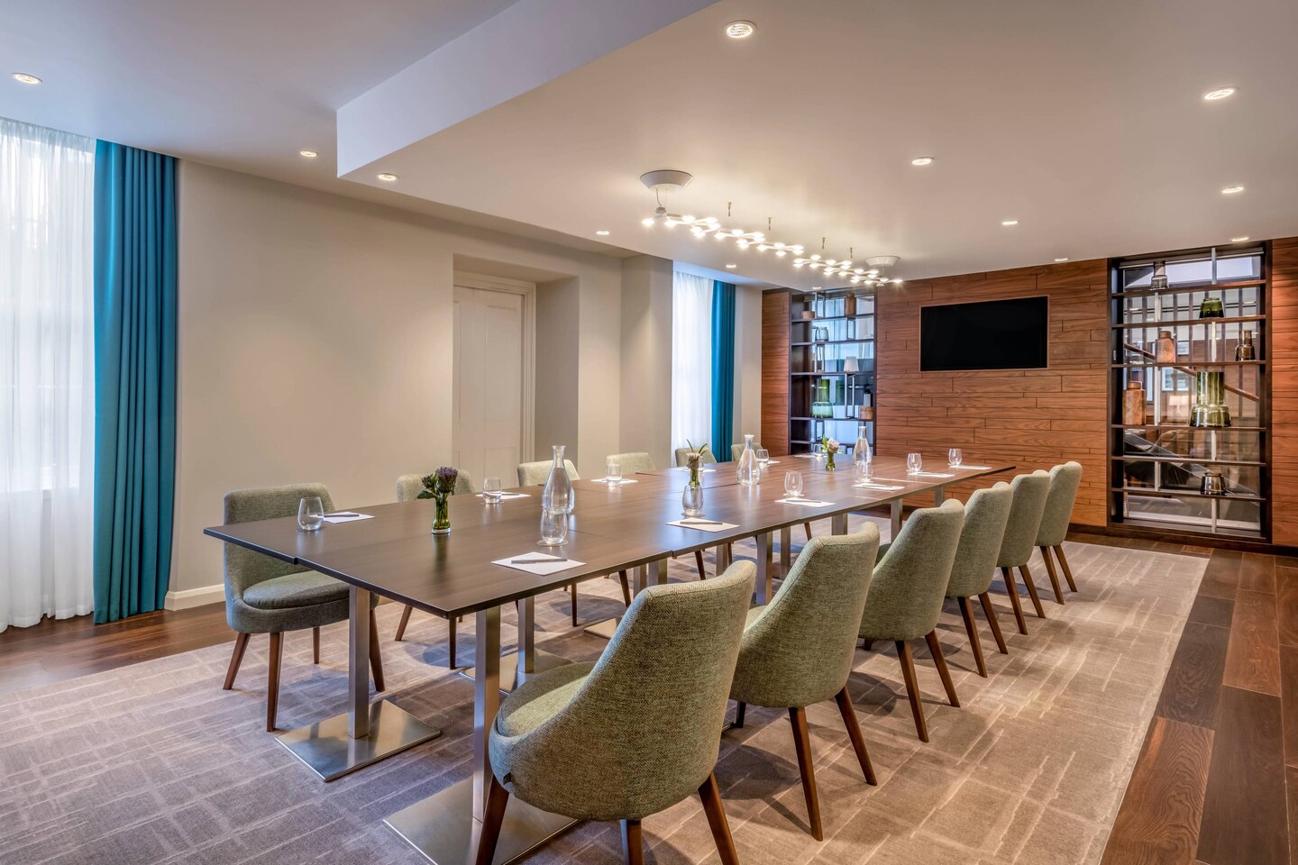 Modern meeting room with sleek table and natural light at Courtyard by Marriott Edinburgh.
