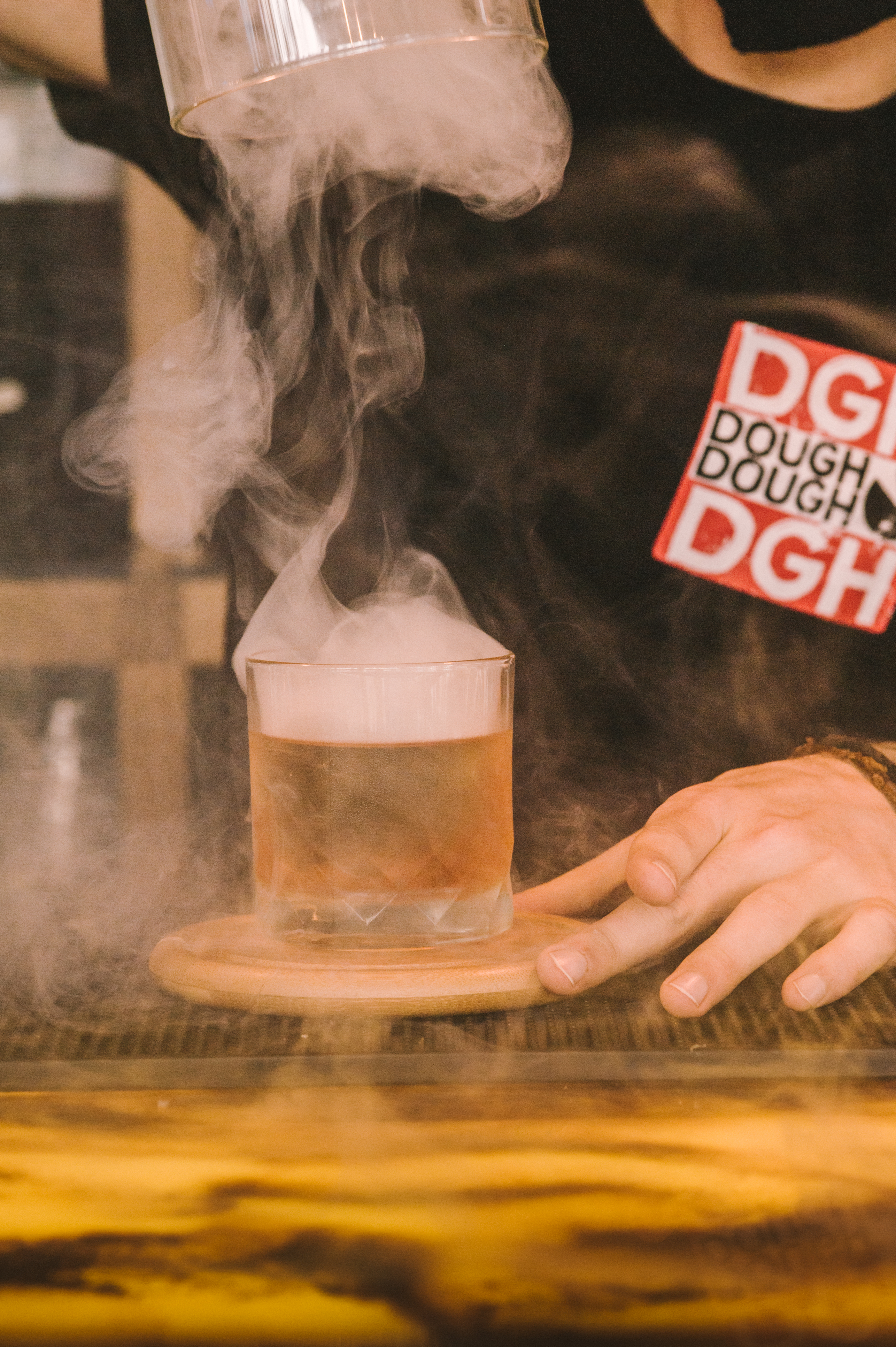 Creative cocktail with smoke effect at Dough Dough Liverpool for memorable events.