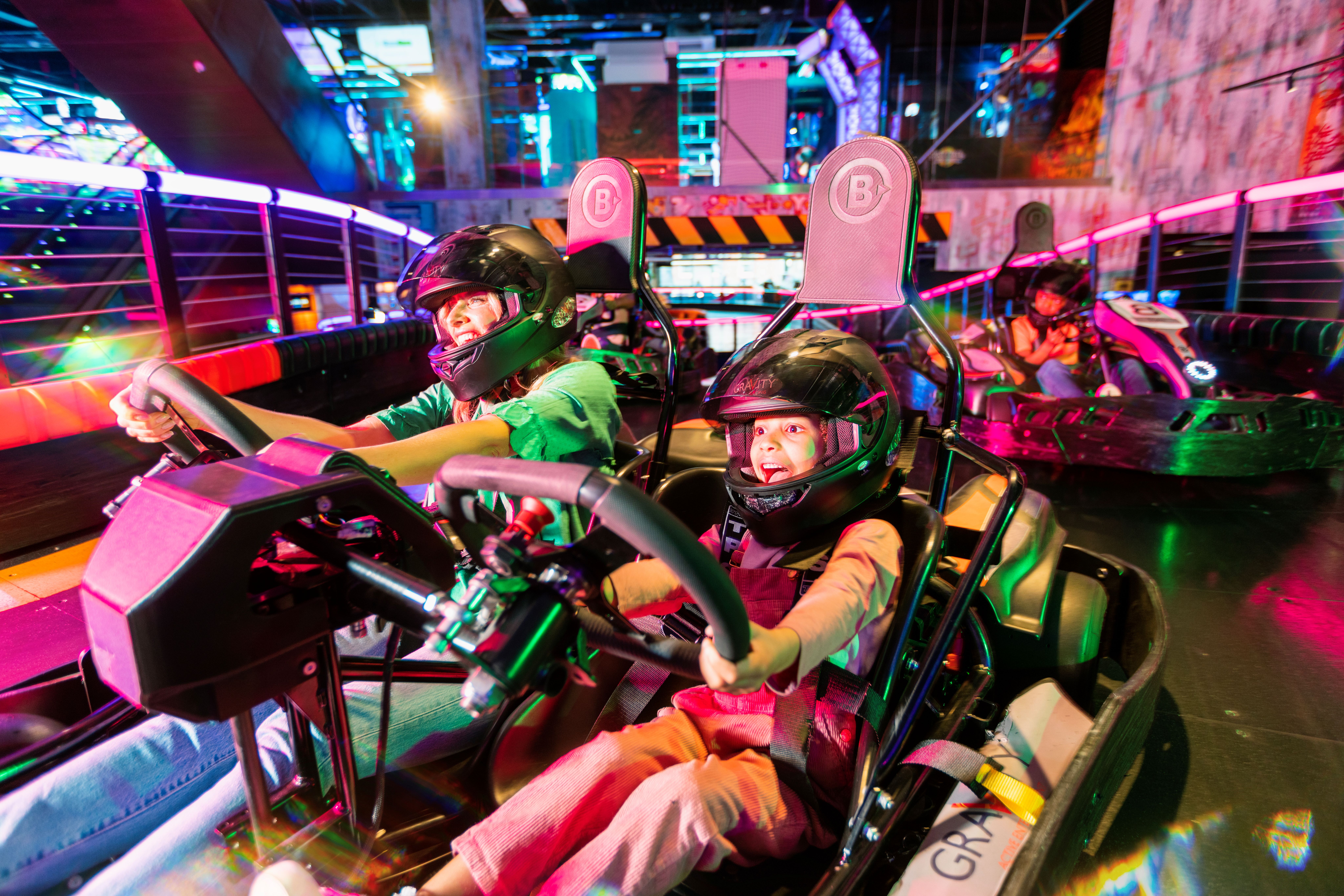 Indoor go-kart racing venue with vibrant lighting for team-building events in Wandsworth.