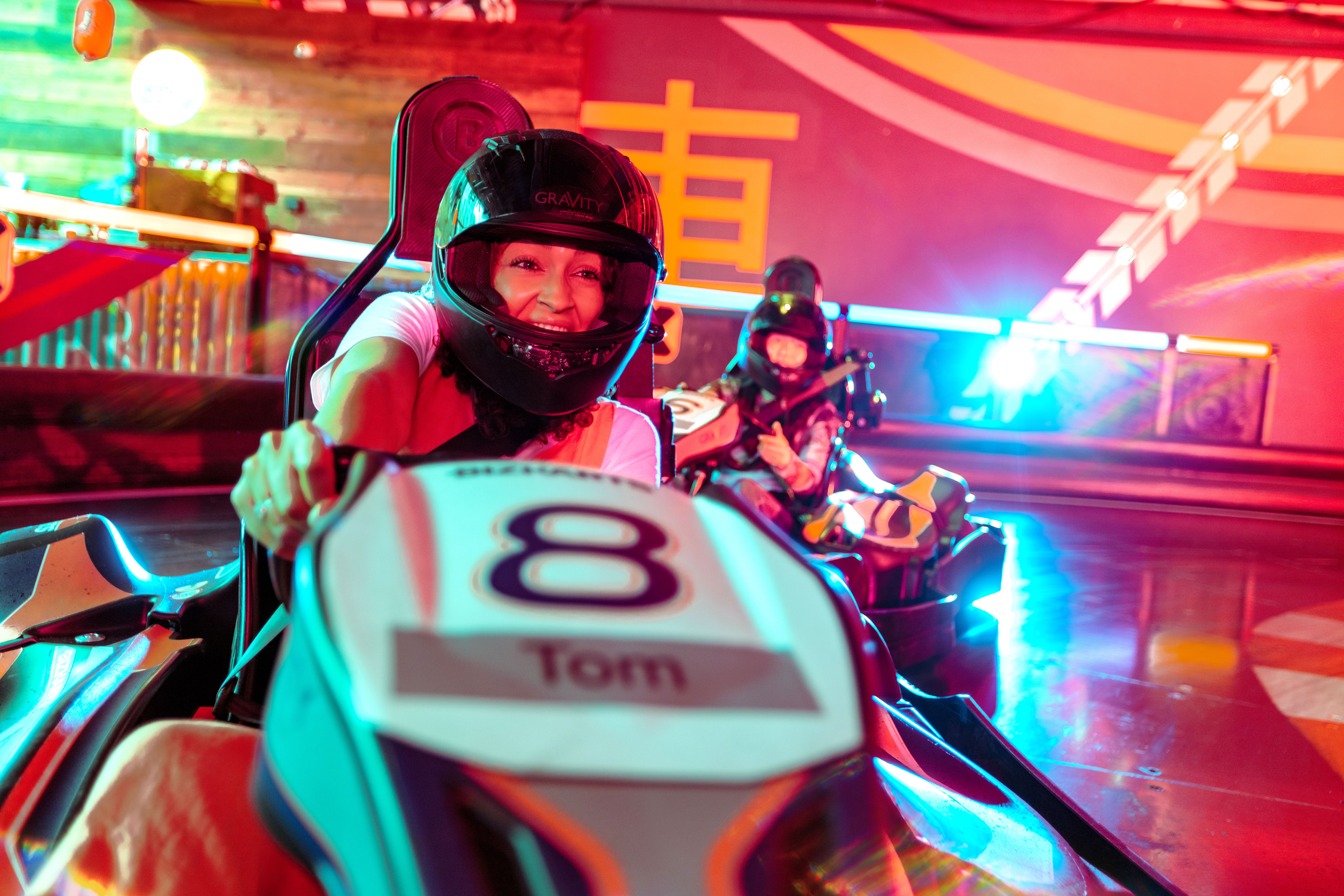 Indoor go-kart racing at GT E-KARTING, vibrant atmosphere for team-building events.