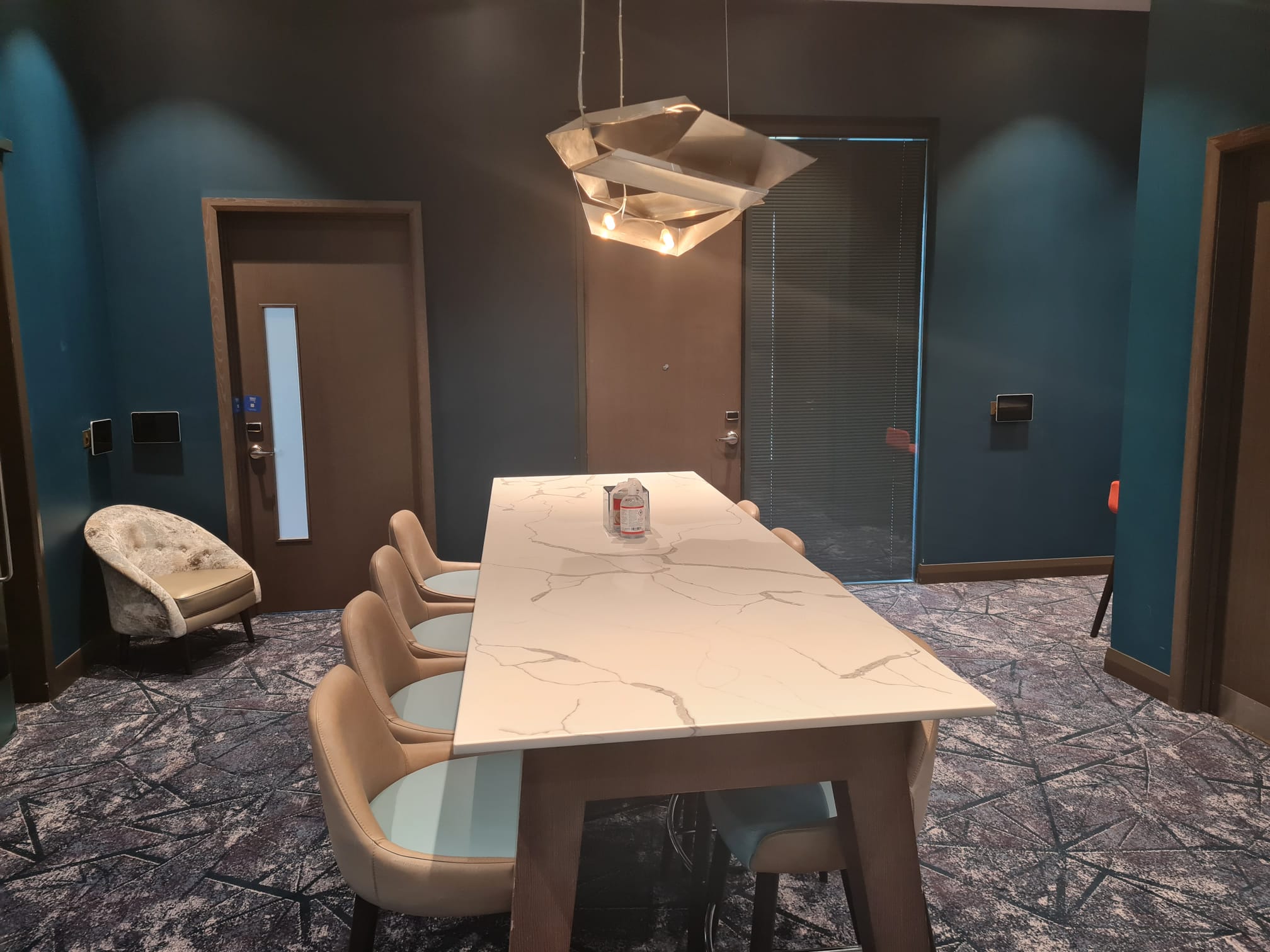 Modern meeting room at Hilton Aberdeen TECA with sleek marble table for events.