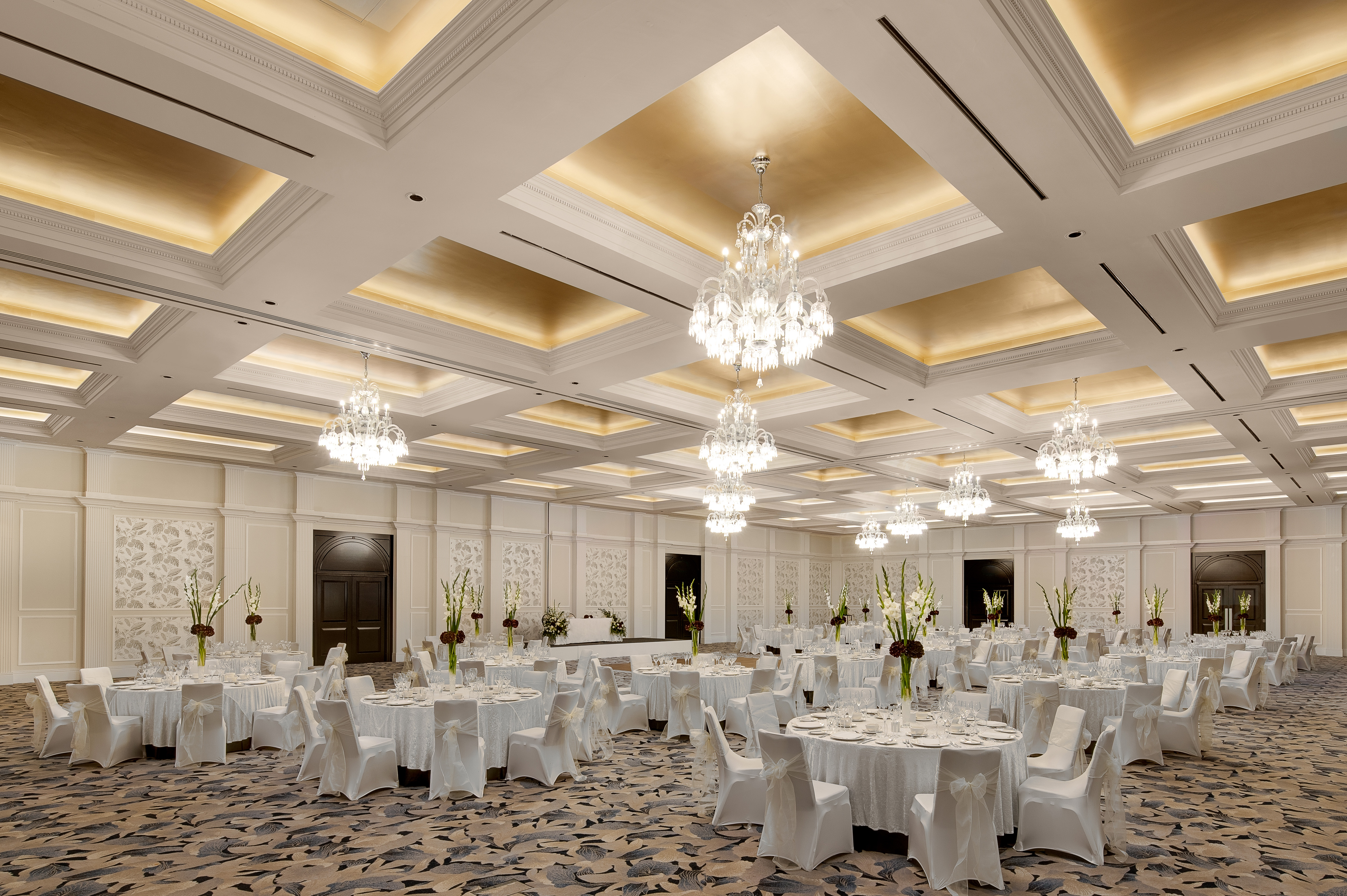 Elegant Arora Ballroom with chandeliers, ideal for corporate events and formal gatherings.
