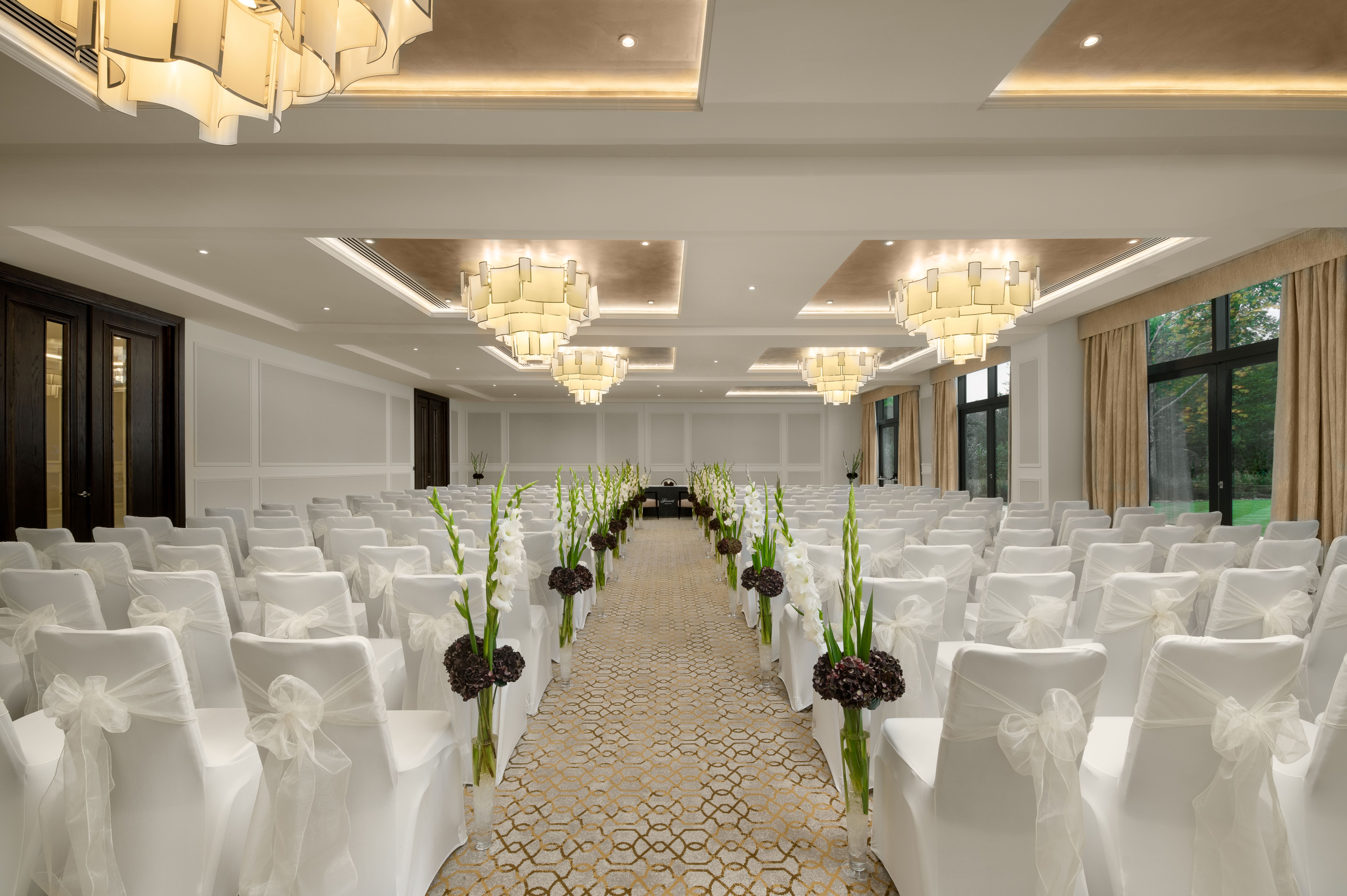 Monarch Suite at Fairmont Windsor Park, elegant wedding venue with white chairs and floral accents.
