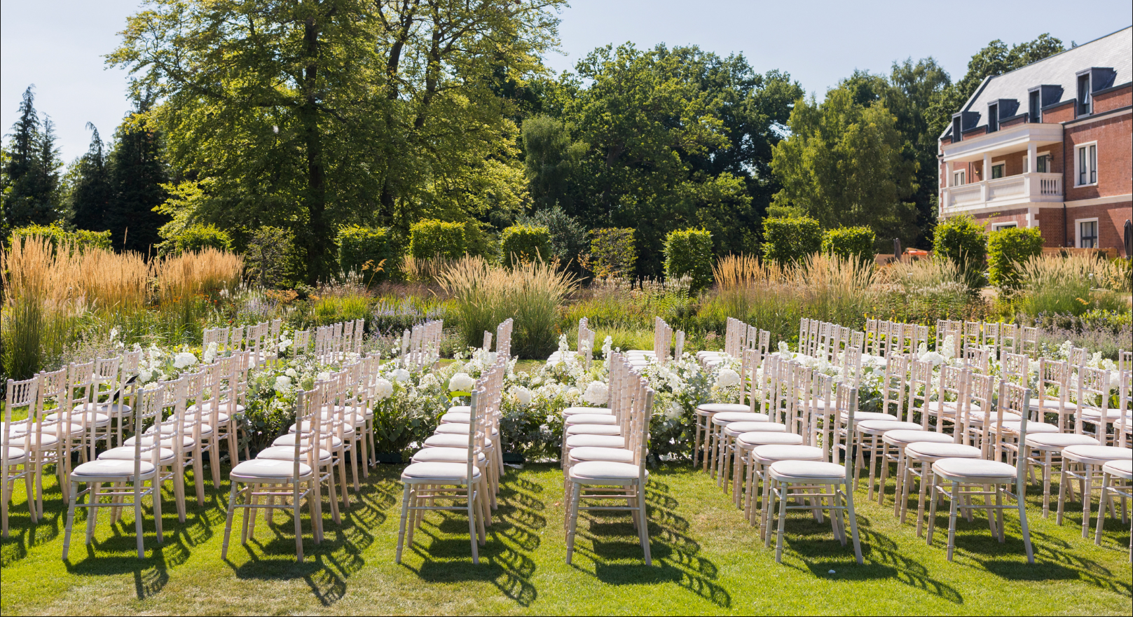Monarch Suite outdoor event space with elegant white chairs, perfect for weddings.