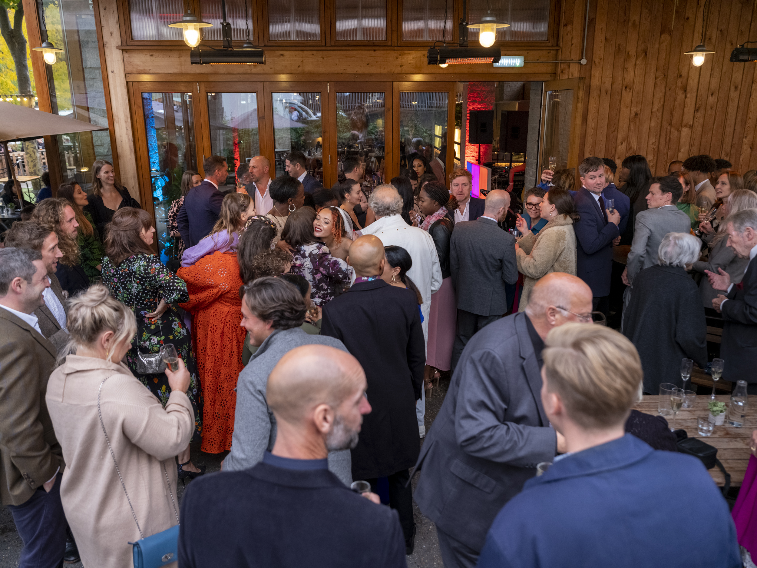 Vibrant networking event at The Terrace with warm lighting and diverse attendees.