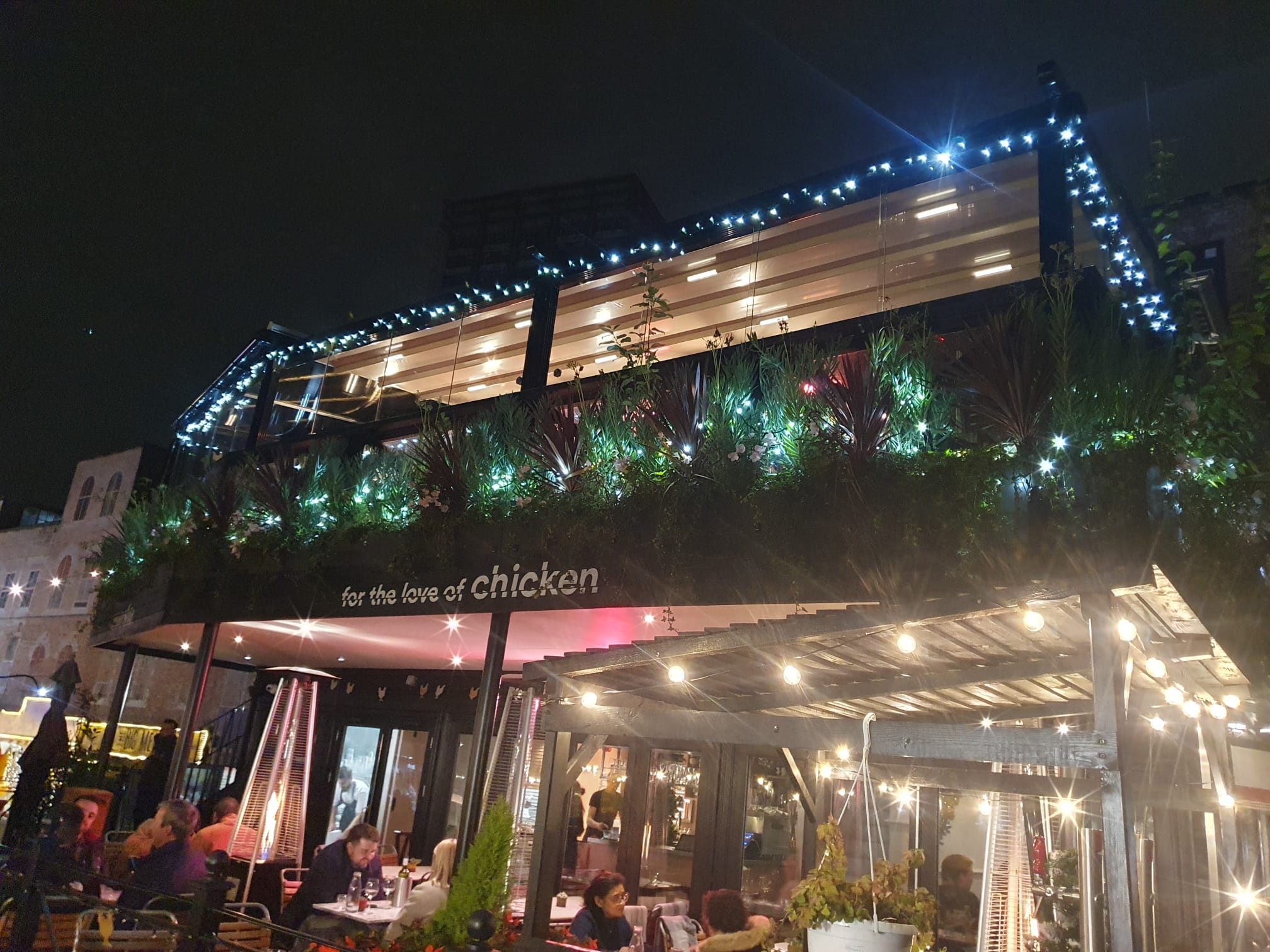 Heated covered terrace in Paradiso London, ideal for events with warm lighting and greenery.