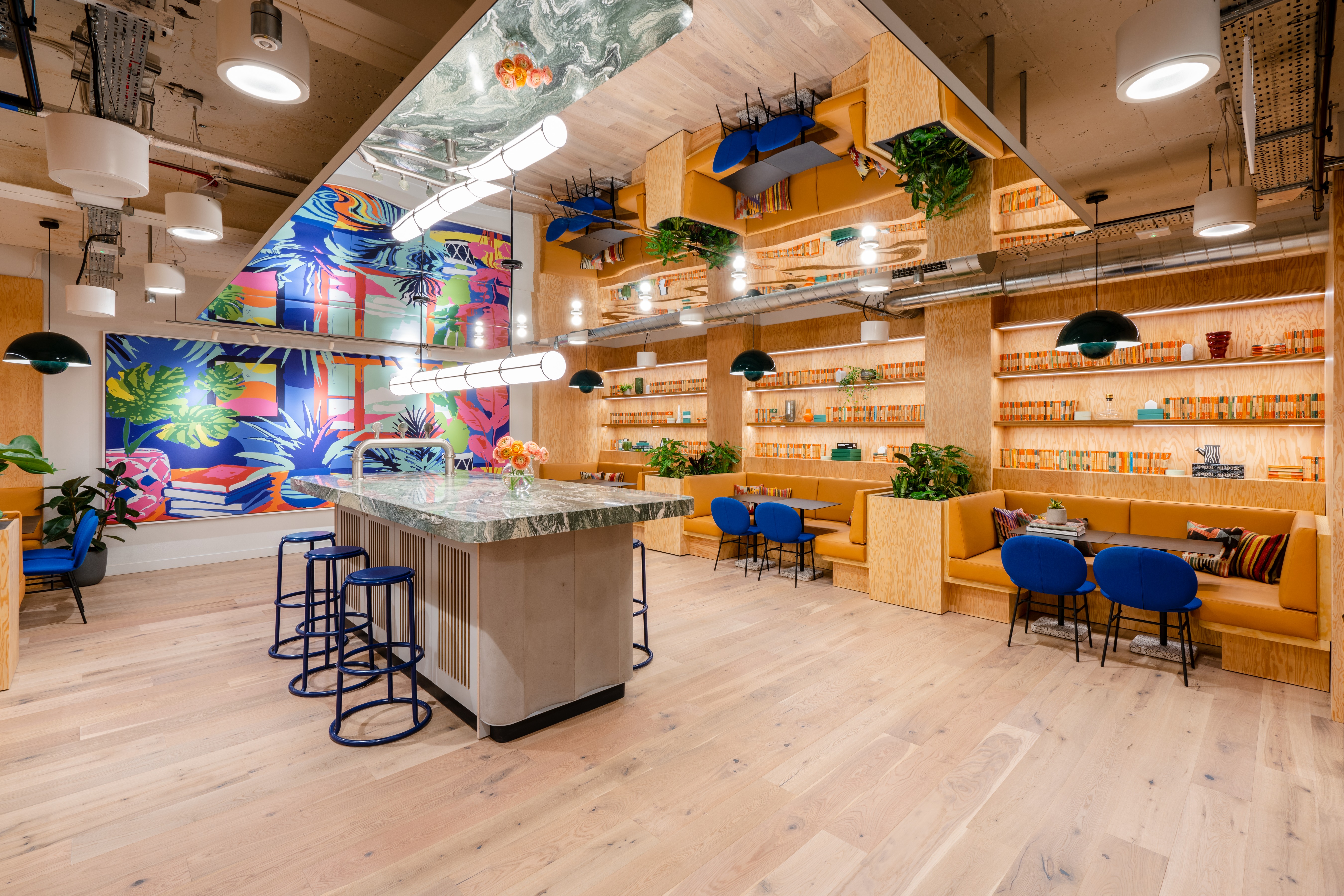 Vibrant meeting space with colorful mural, ideal for creative events and collaboration.