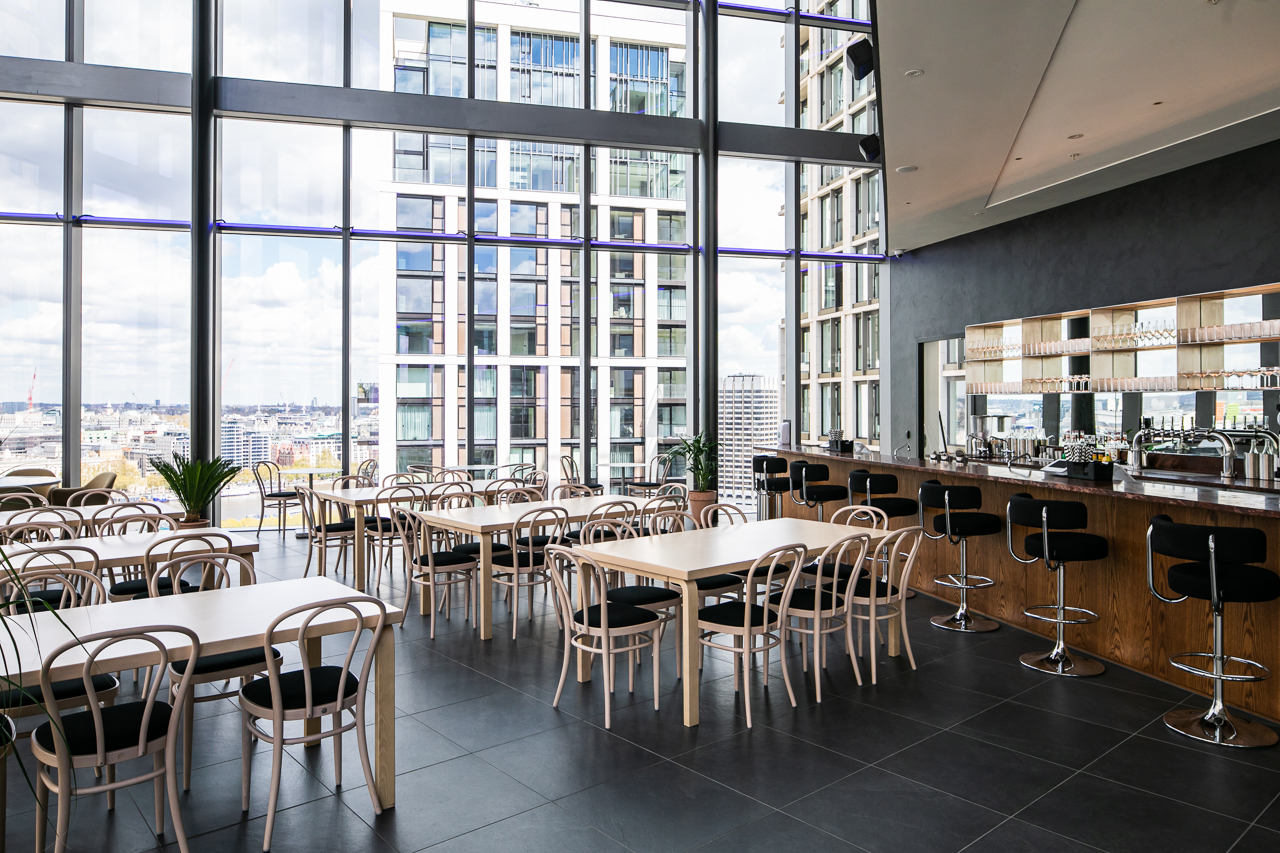Modern event space with floor-to-ceiling windows, ideal for networking and receptions.