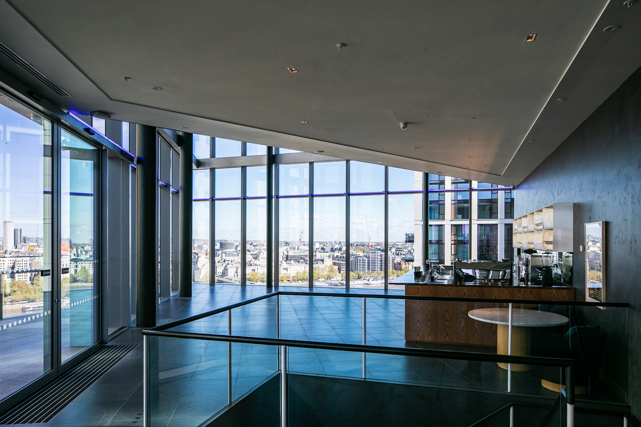 Modern event space with floor-to-ceiling windows, ideal for corporate meetings and receptions.
