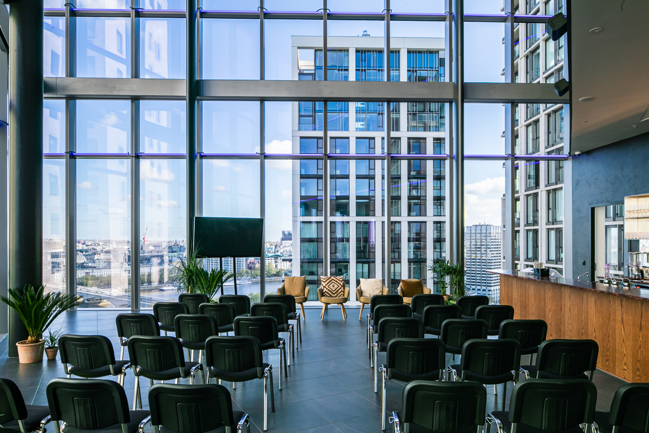 Modern event space with floor-to-ceiling windows, ideal for meetings and conferences.