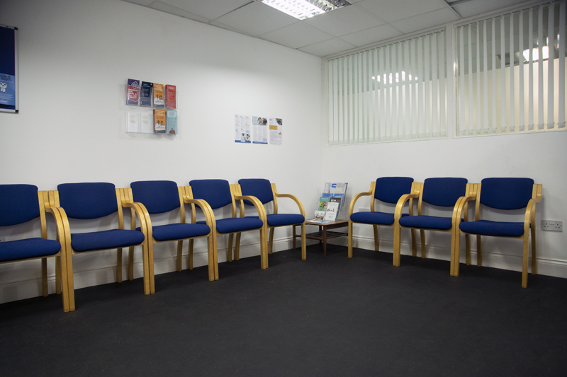 Medical GP hospital waiting area with blue chairs, ideal for briefings and meetings.